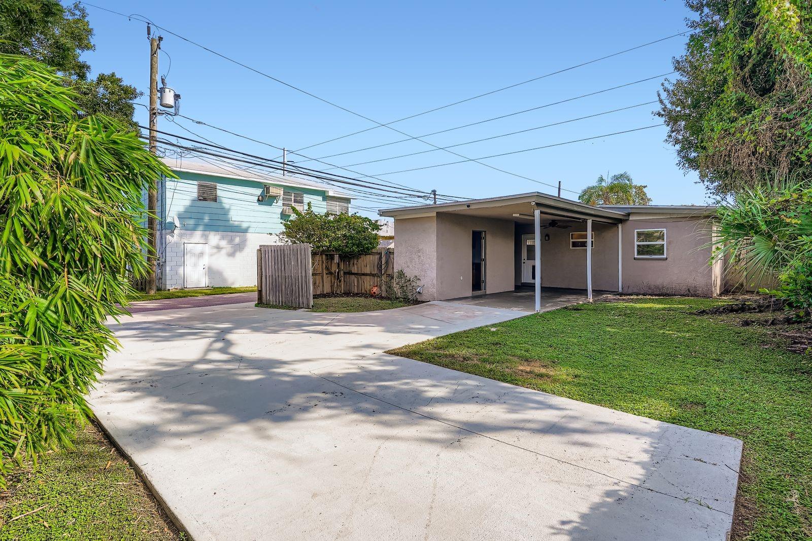 DRIVEWAY, PARKING PAD W/ COVERED PATIO WITH SECURE GATE