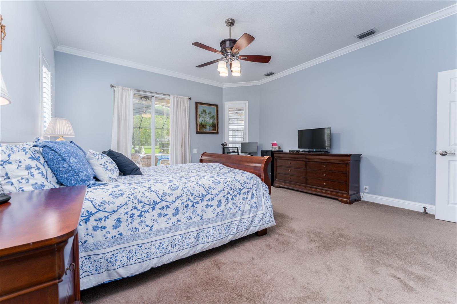Spacious Primary Suite with Sliders that Lead to Outdoor Living Space