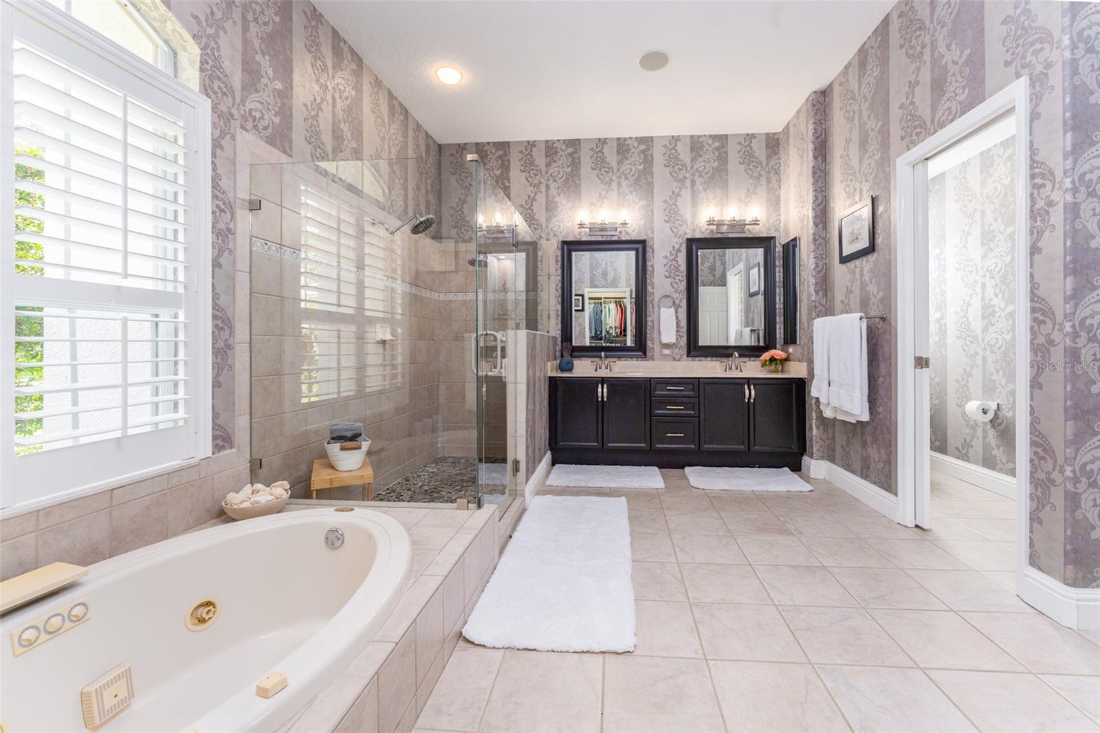 Primary EnSuite Bath with Walk in Shower with Frameless Door, New Tile Flooring & Dual Vanities