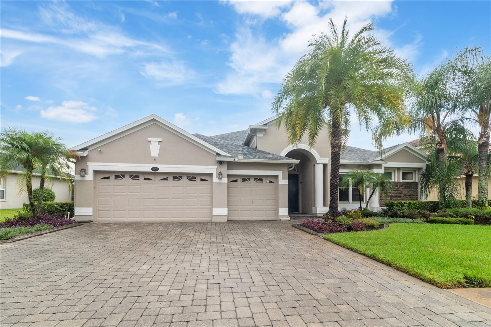 3 car garage with a paved driveway