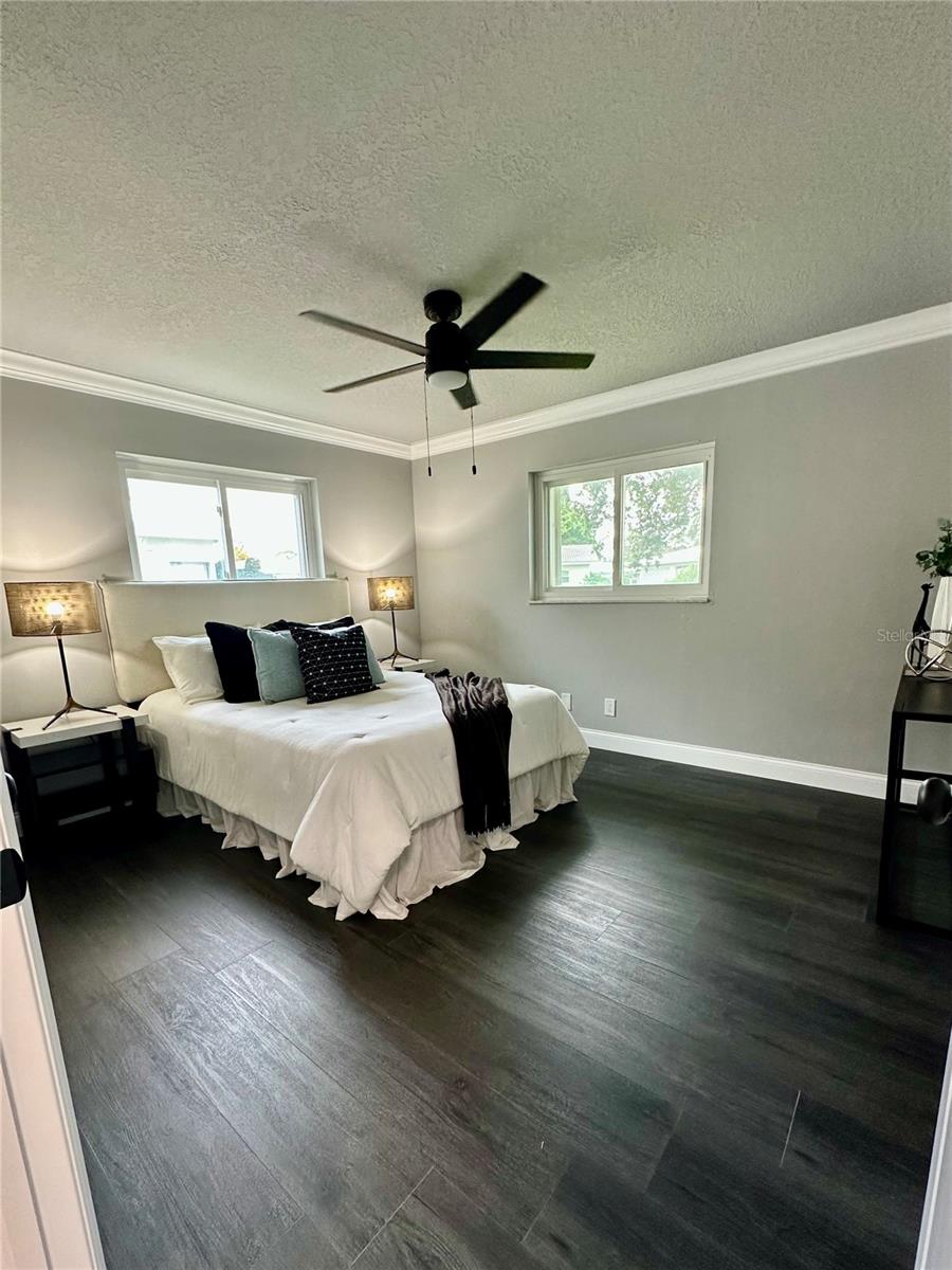 Primary Bedroom with luxury vinyl plank flooring, walk-in closet, and ensuite bathroom.