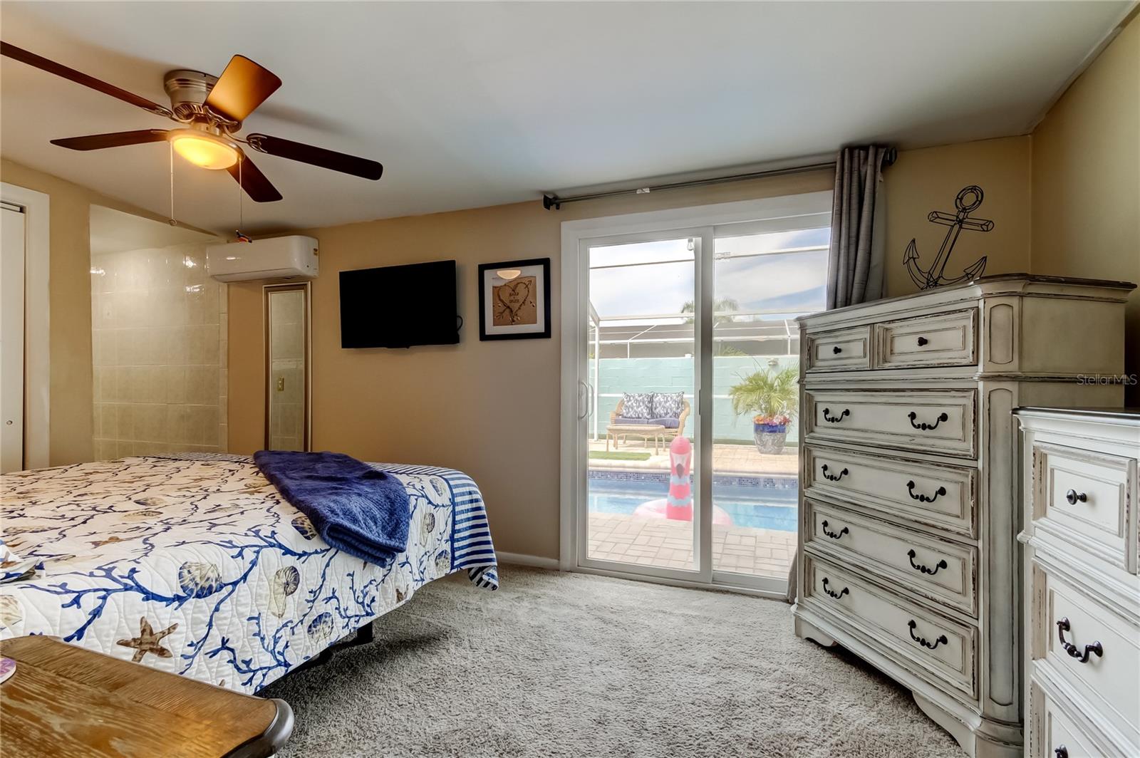 Primary bedroom with sliders to the pool.