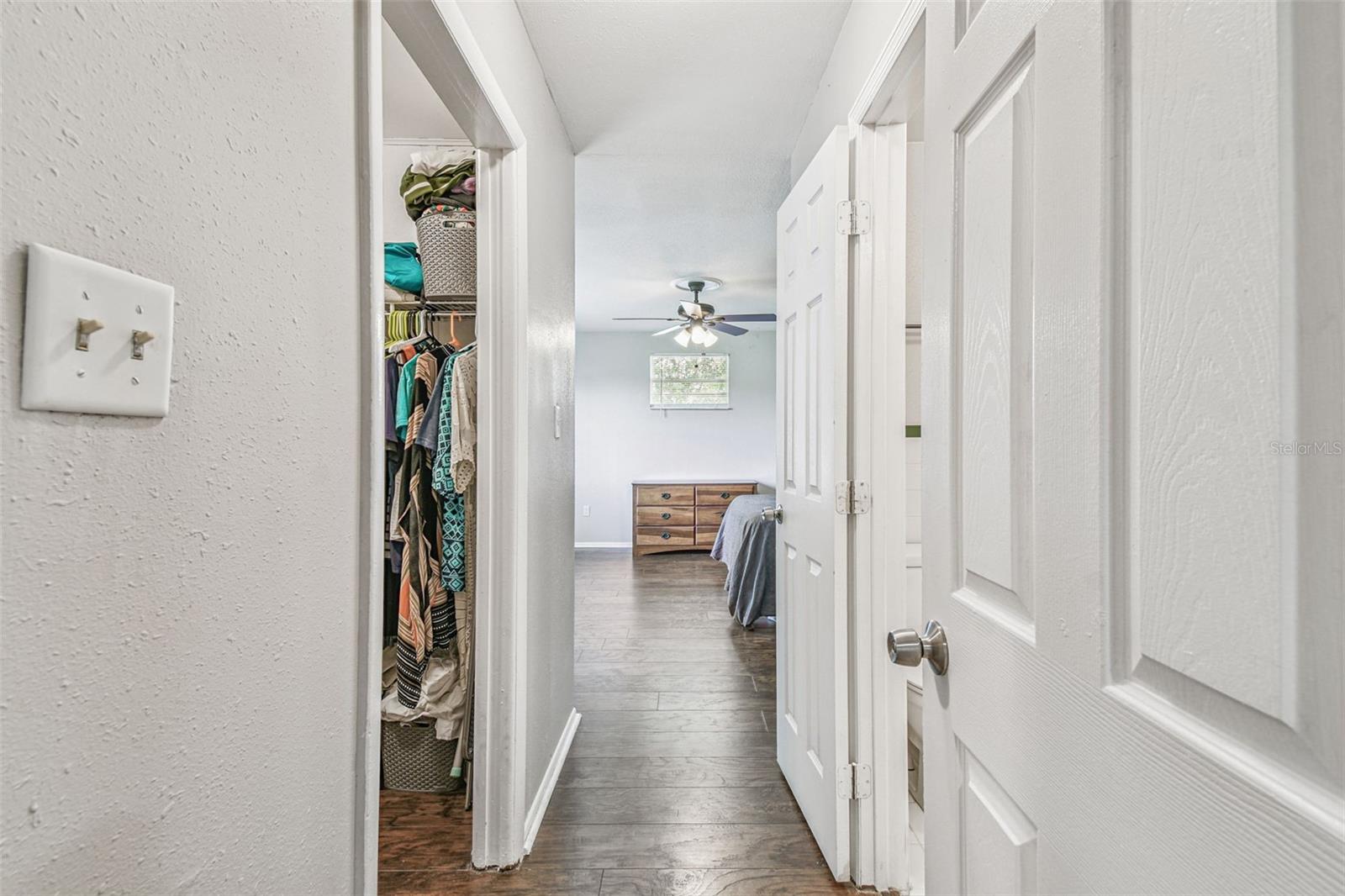 Hallway leading from the living room into the primary suite.