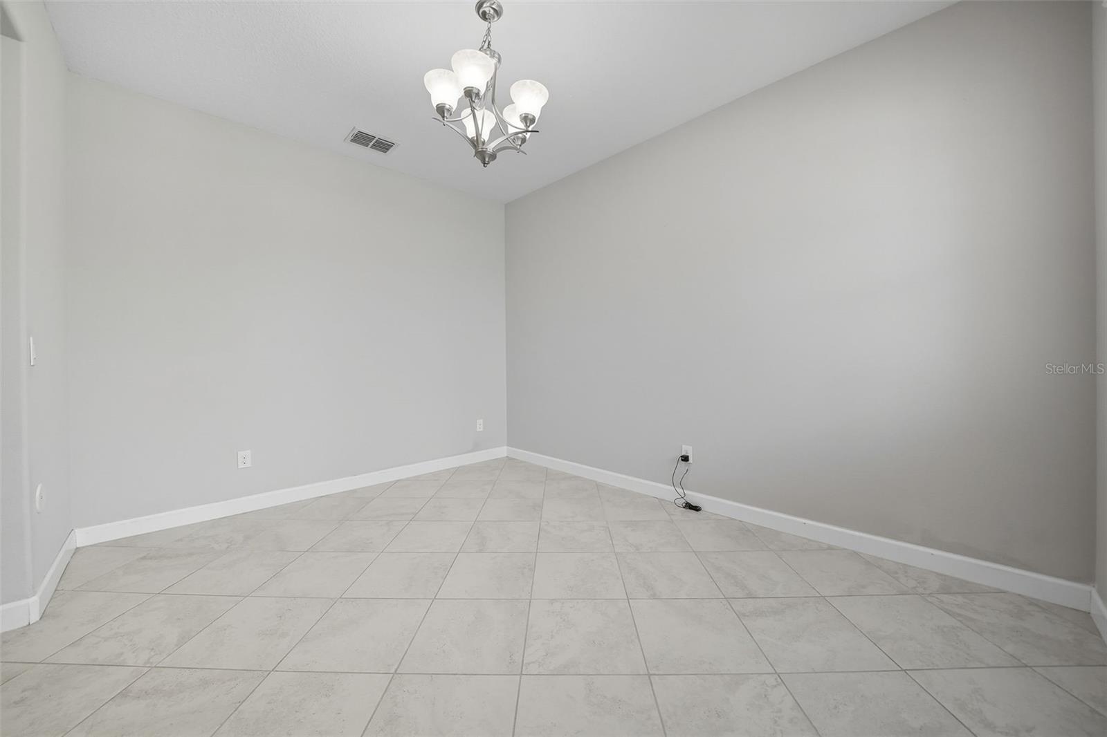 Elegant formal dining room with tile flooring and modern lighting—perfect for hosting gatherings and special occasions