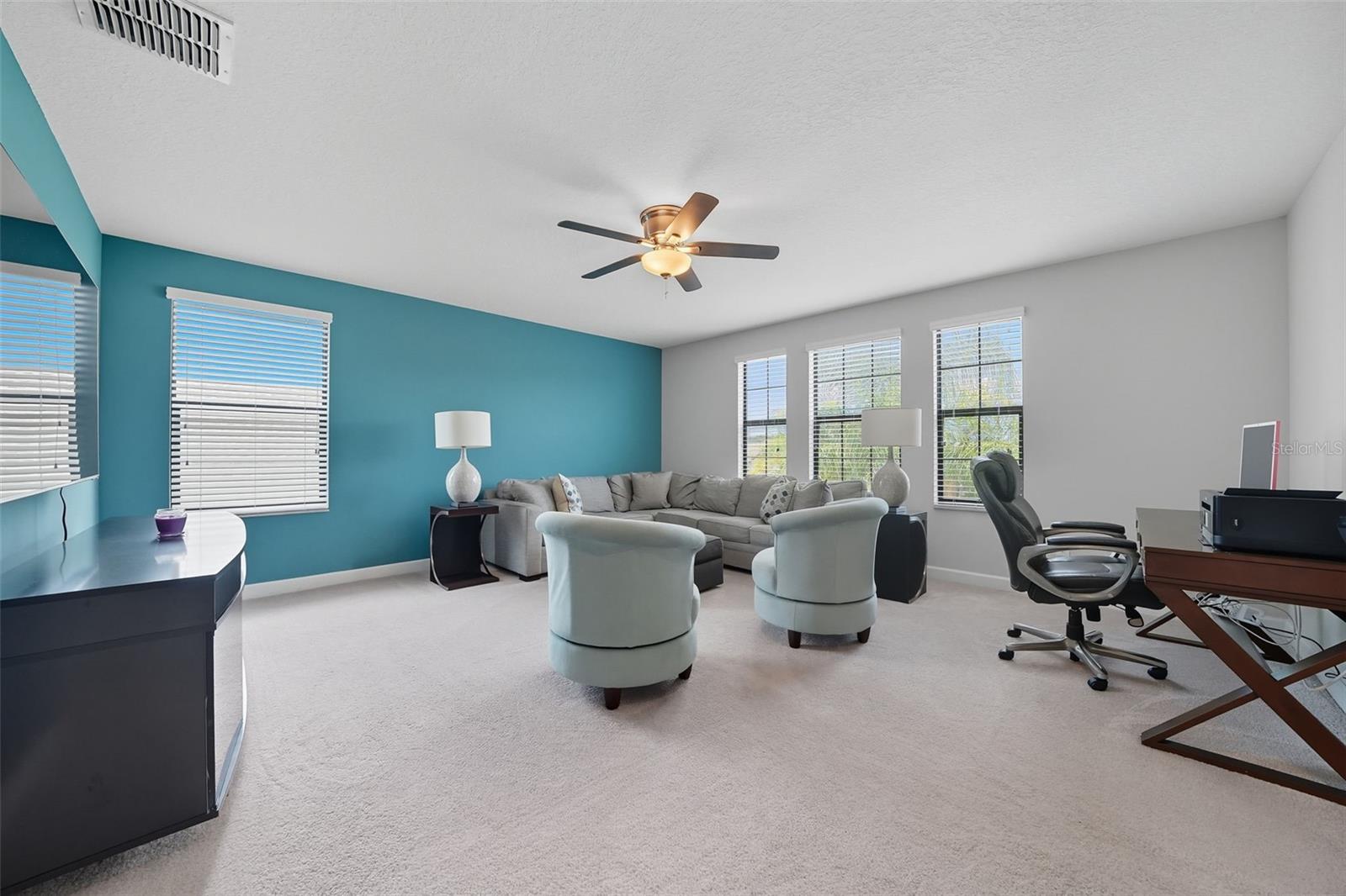 Huge upstairs loft with abundant natural light—ideal as a second living room, playroom, home office, or media space .