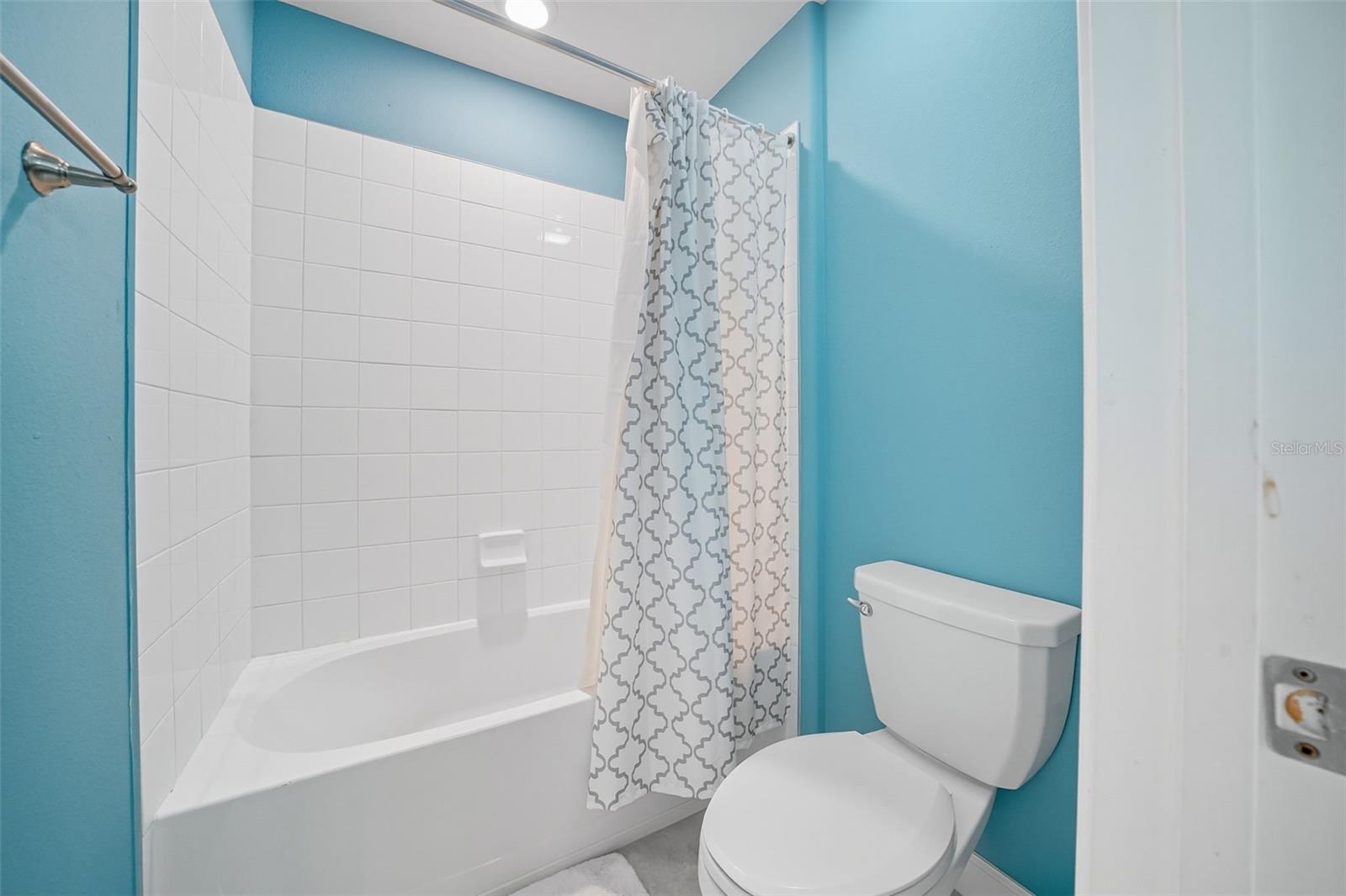 Upstairs bathroom with a smart split design—granite double vanity separate from the shower/tub and toilet, offering convenience for busy households
