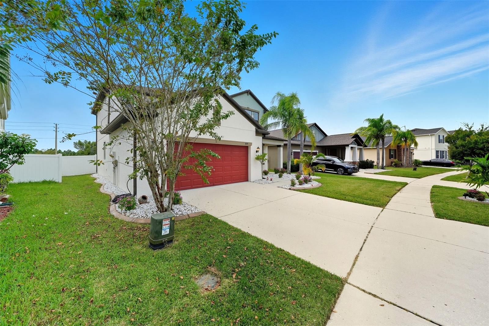 Spacious driveway with plenty of parking and a fully fenced backyard for privacy. Beautiful landscaping surrounds the home, giving it a fresh and welcoming feel from every angle