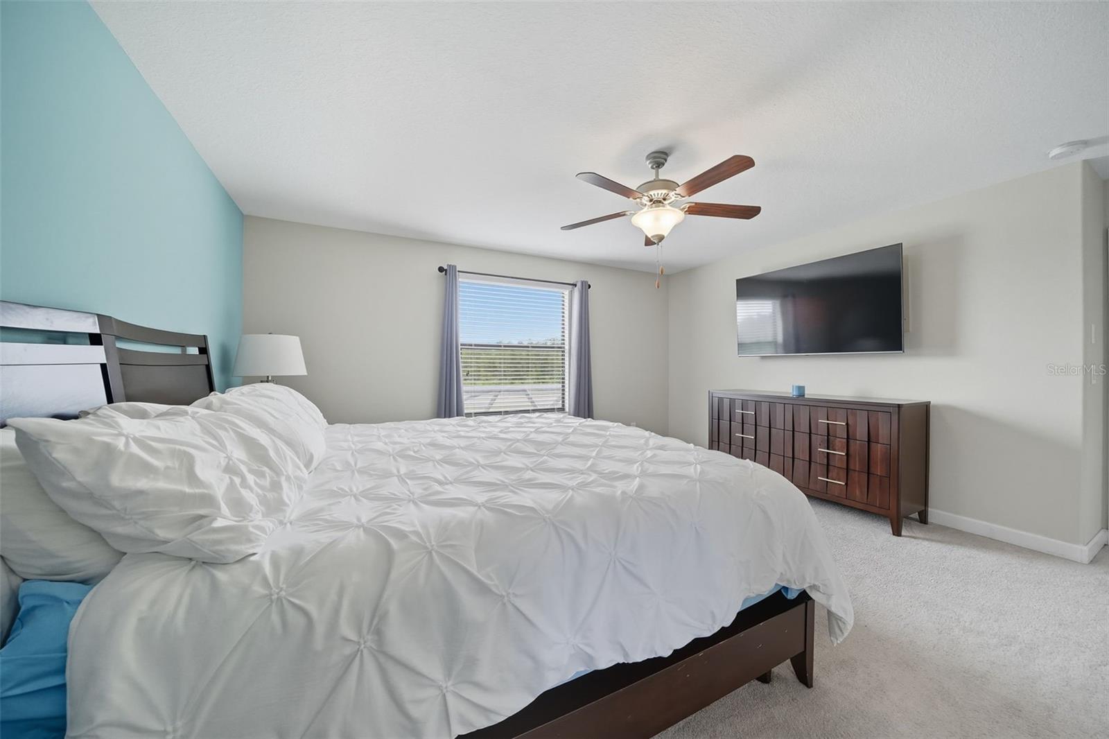 Another view of the primary suite showcasing its generous layout—perfect for a king bed, large furniture, and even a mounted TV for your private retreat