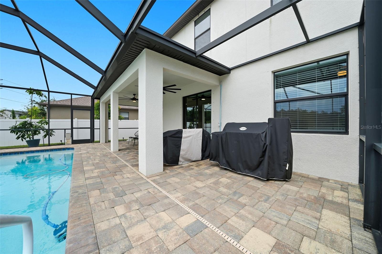 This screened-in lanai offers plenty of space for grilling and outdoor dining — perfect for weekend BBQs, entertaining guests, or simply enjoying the Florida sunshine by the pool