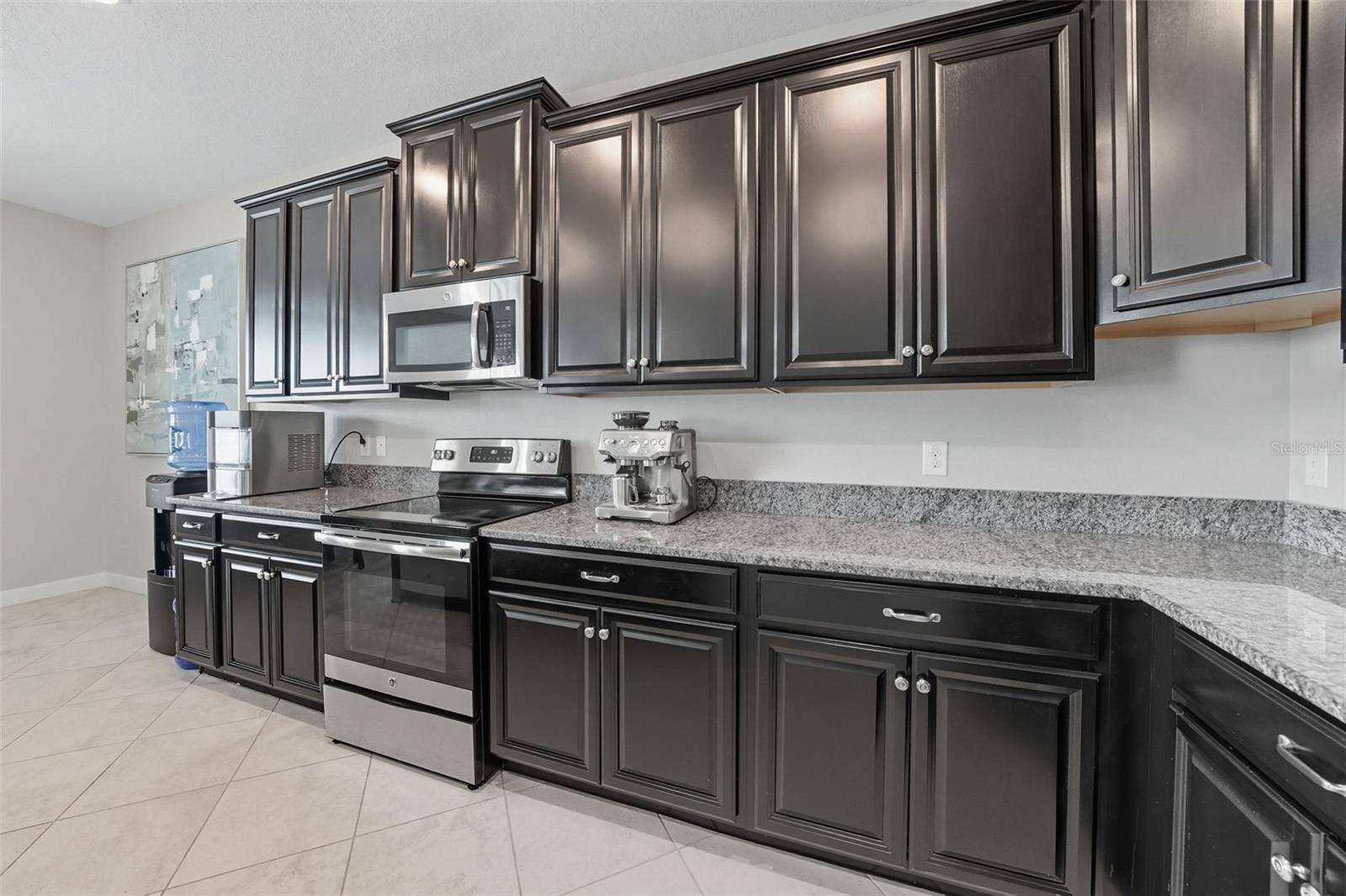 Beautifully upgraded kitchen featuring sleek granite countertops, rich cabinetry, and stainless steel appliances. A perfect blend of style and function with plenty of prep and storage space