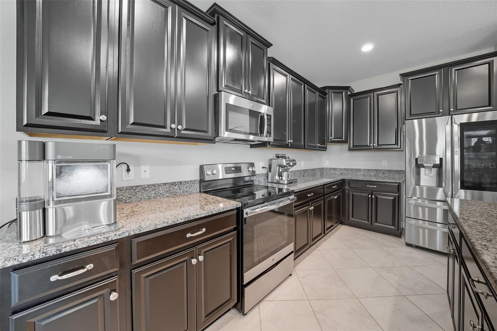 Spacious kitchen with expansive granite countertops, abundant cabinet storage, and stainless steel appliances. The open layout makes it perfect for both everyday living and entertaining