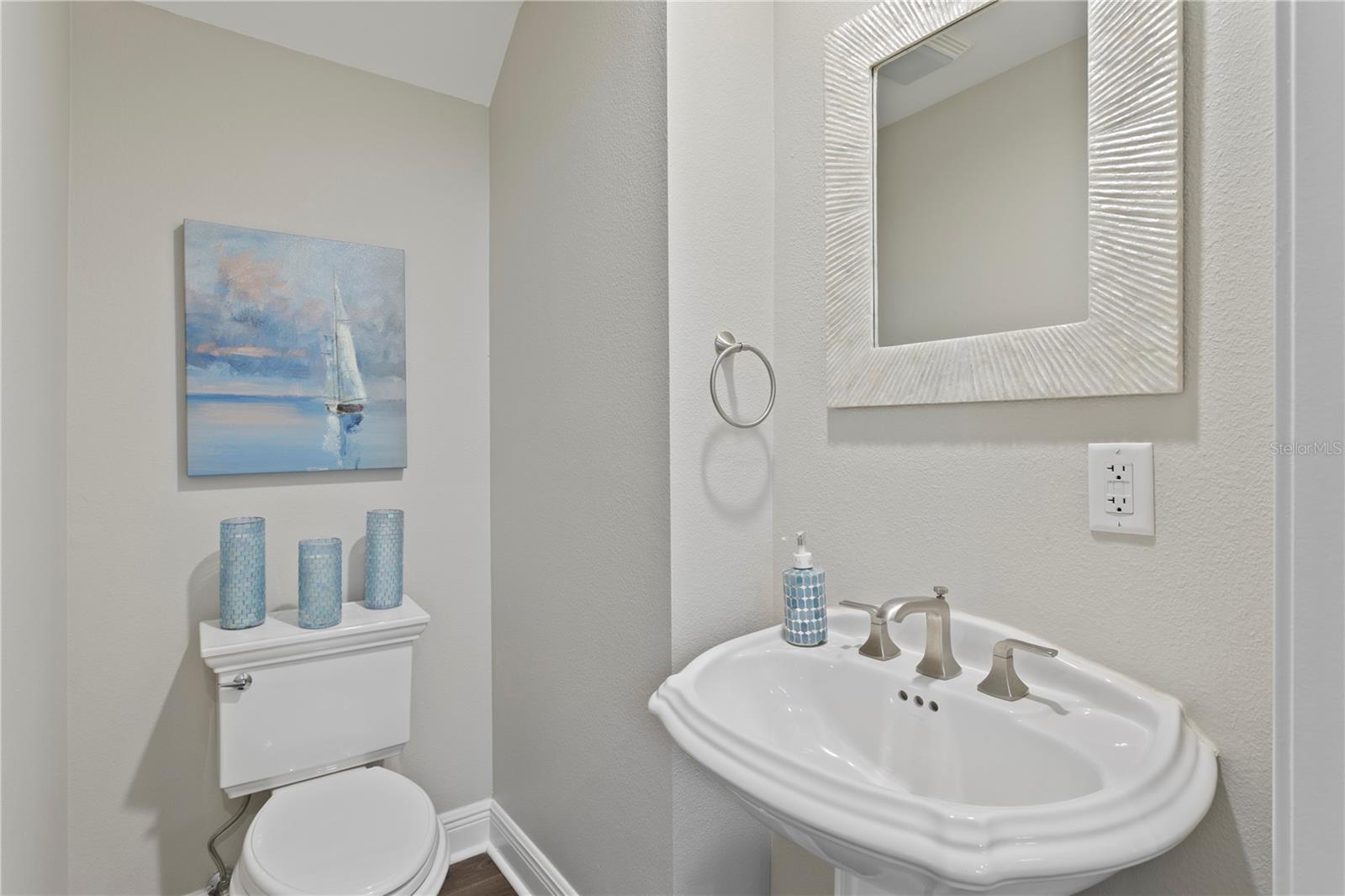 Powder bath nestled downstairs adjacent to the stairs to 2nd level