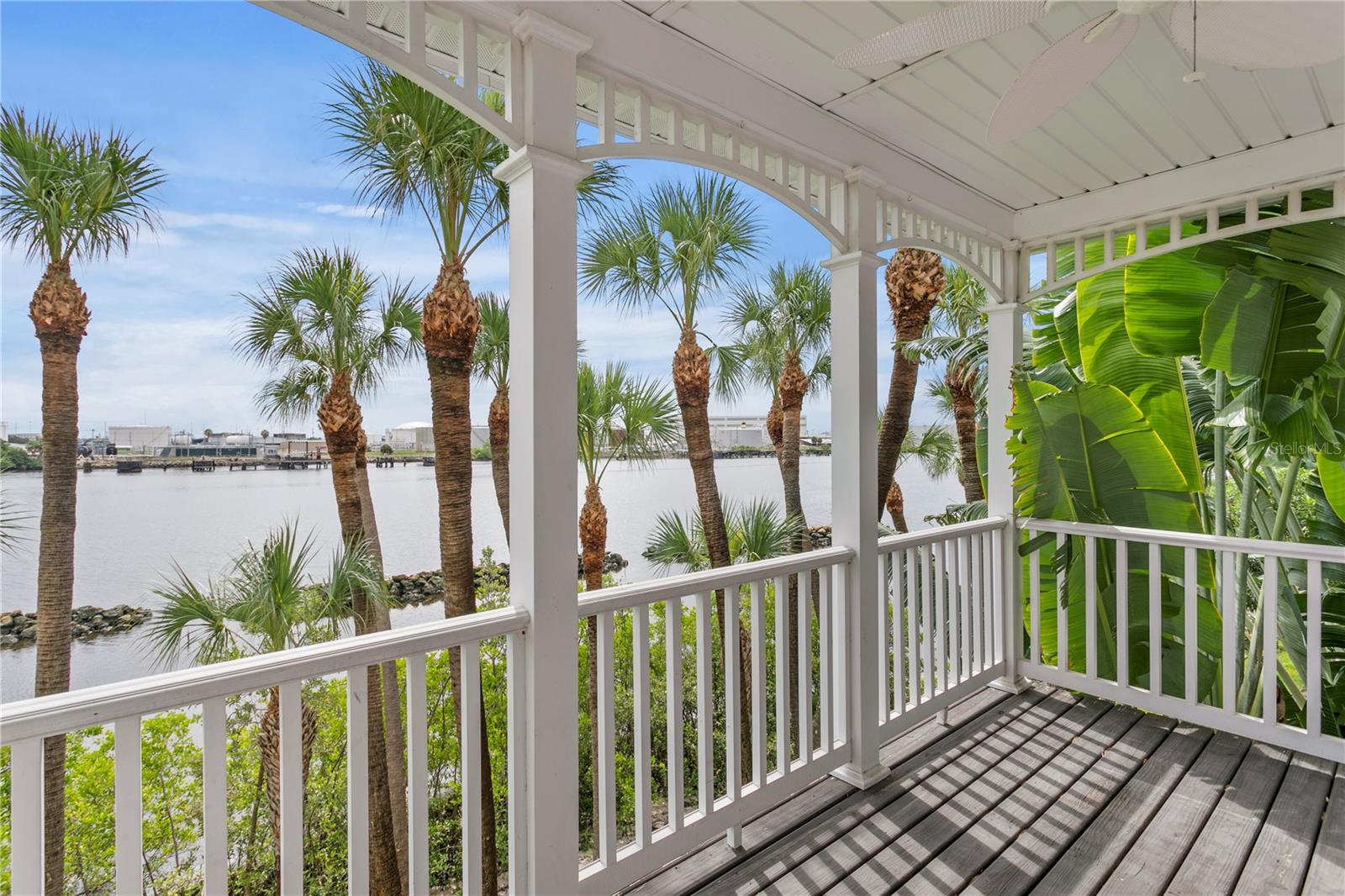 Or . . . . perhaps here on your covered balcony off the primary overlooking the water