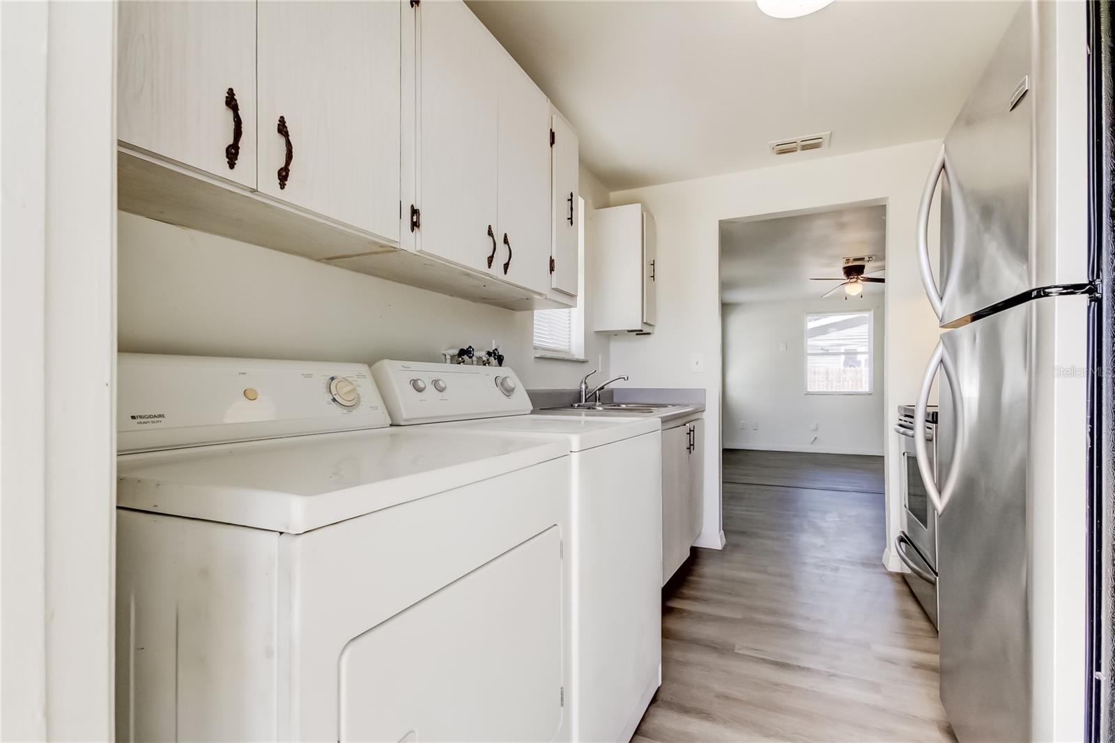 23. Laundry Area in Kitchen (11' x 7.9') - Washer & Dryer Convey with Sale! Cabinets Right Above for Storage!!.