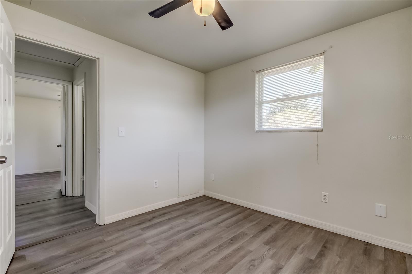 27. Primary Bedroom (10' x 10.2'). Beautiful Driftwood Grey Luxury Vinyl Laminate Flooring in the Primary Bedroom!