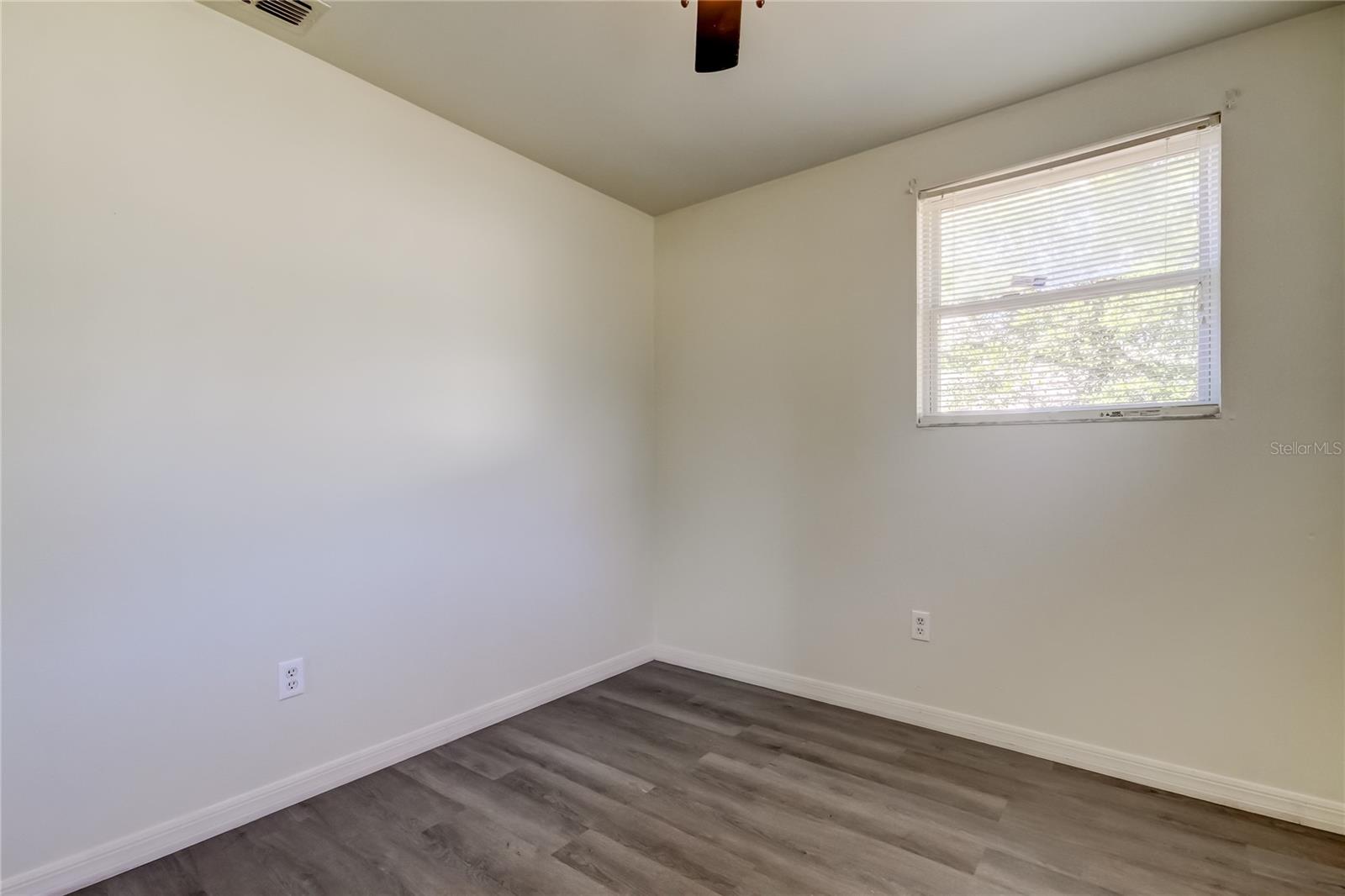 33. Bedroom 2 (8.9' x 9.10'). Beautiful Driftwood Grey Luxury Vinyl Laminate Flooring.