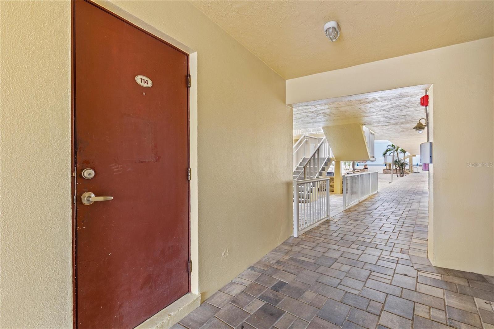 Your private storage unit is just on the other side of that white gate and that is the pool right behind the stairs.