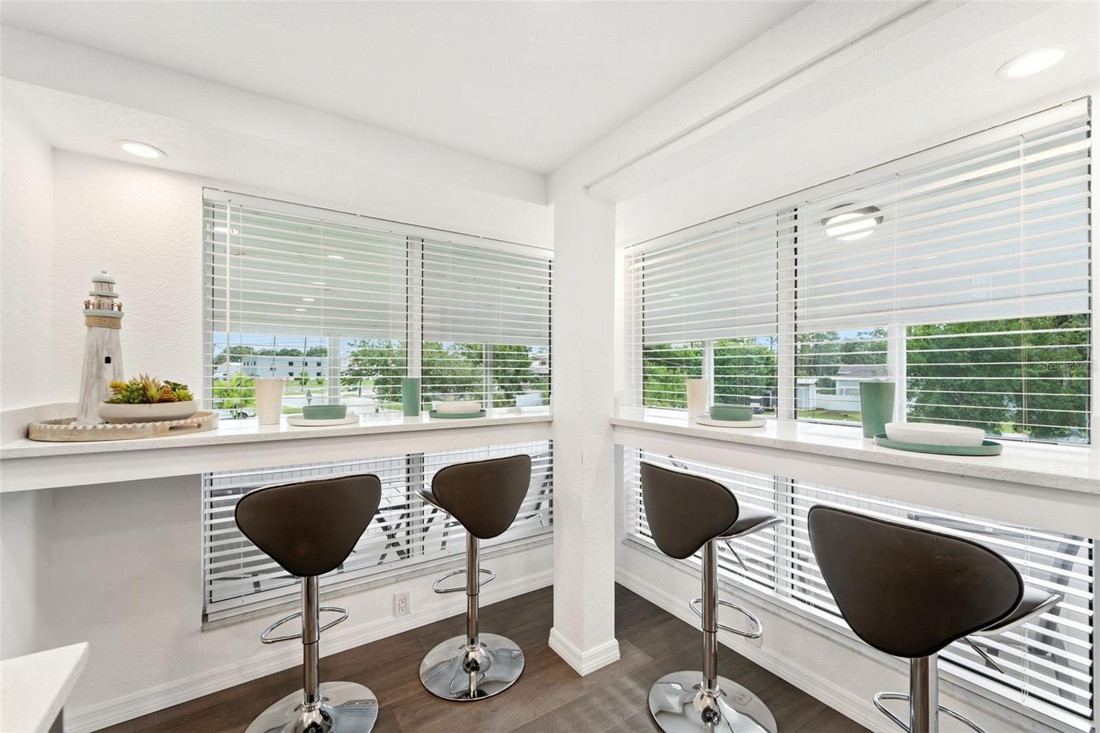 Large windows offering lots of natural light and view while eating in the kitchen bar