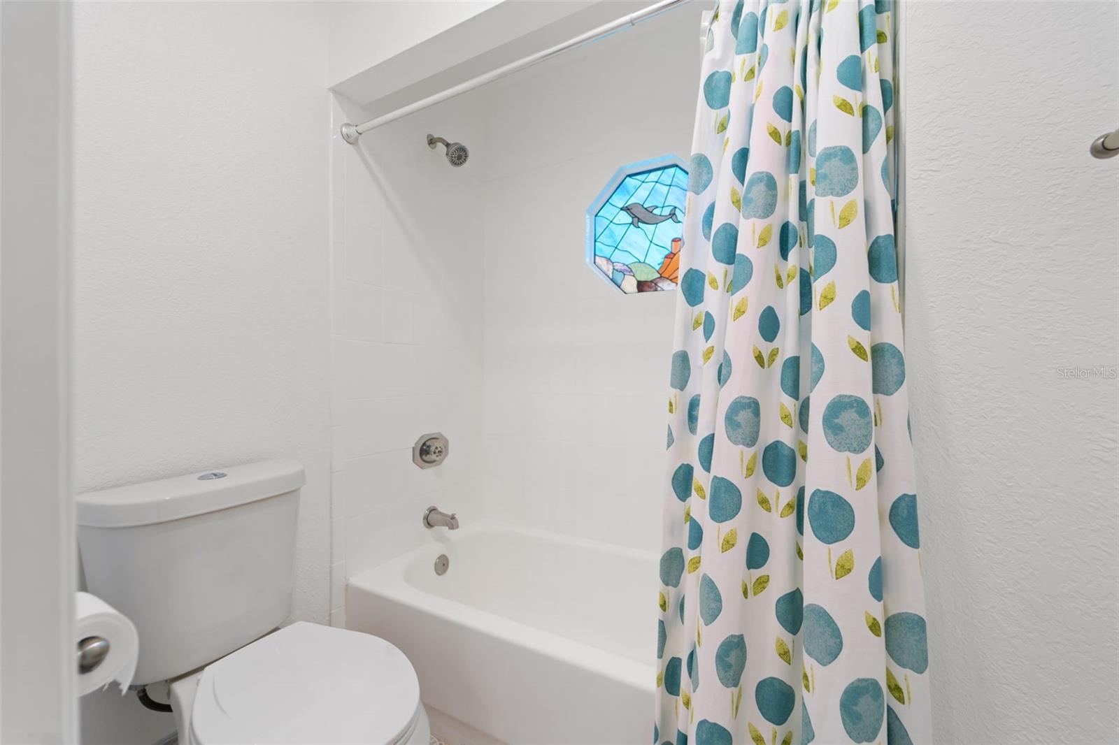 Shower and Tub with a window for lighting.