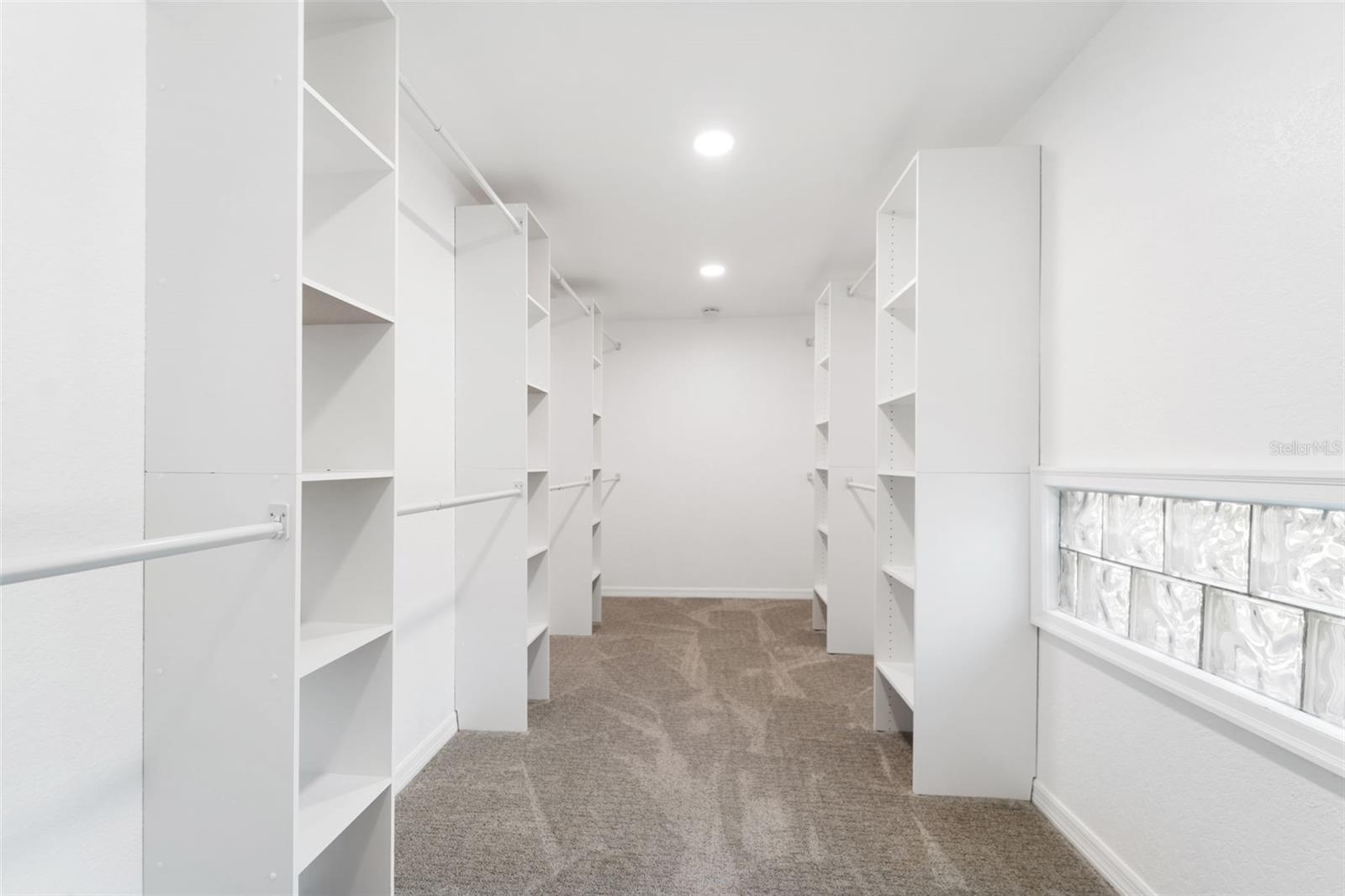 Luxury Designer Walk-in Closet for all your clothes and shoes! even larger in person! Window for natural light to eliminate moisture/mold concerns.