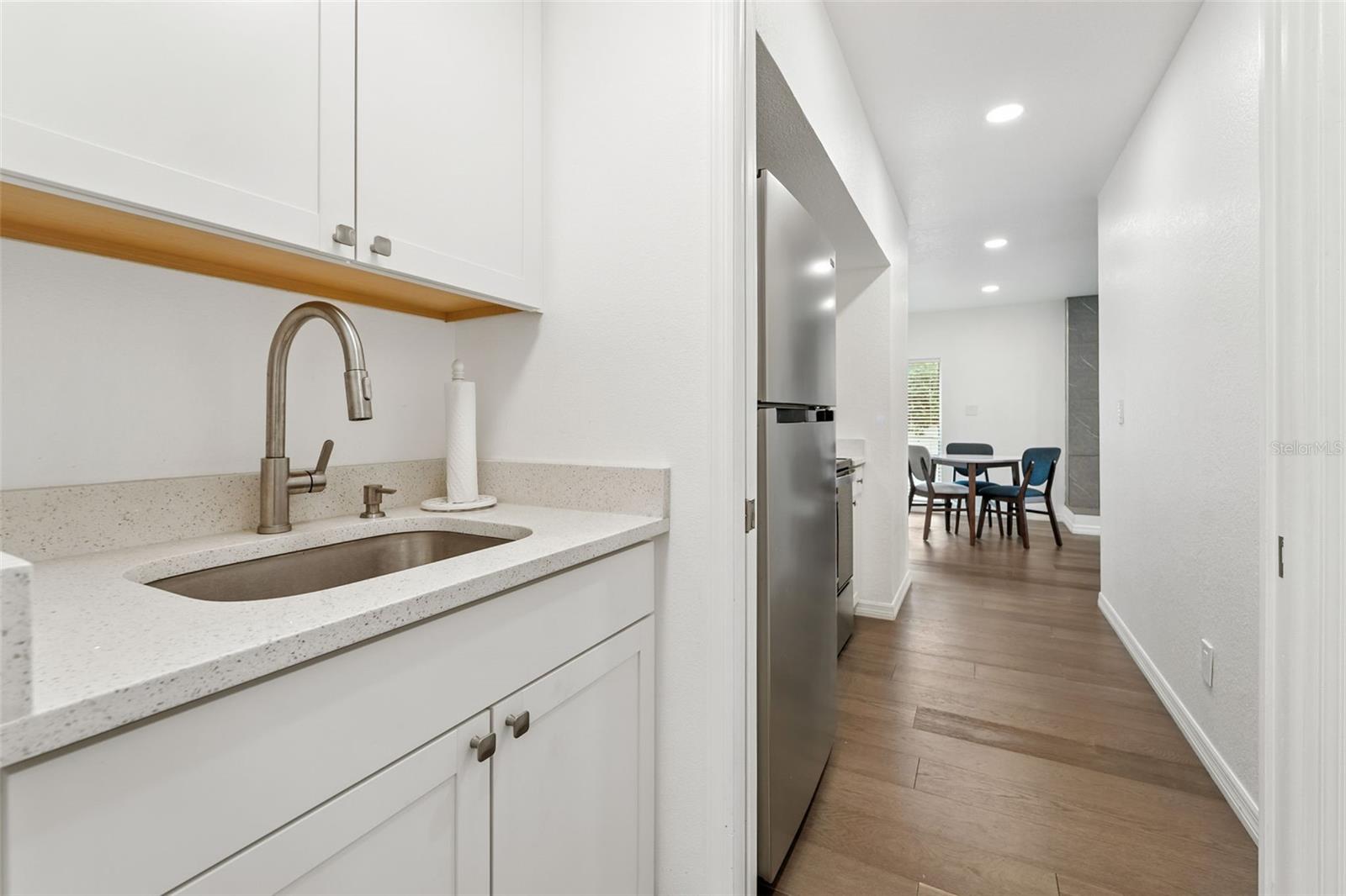 Full size sink with pantry across from it.
