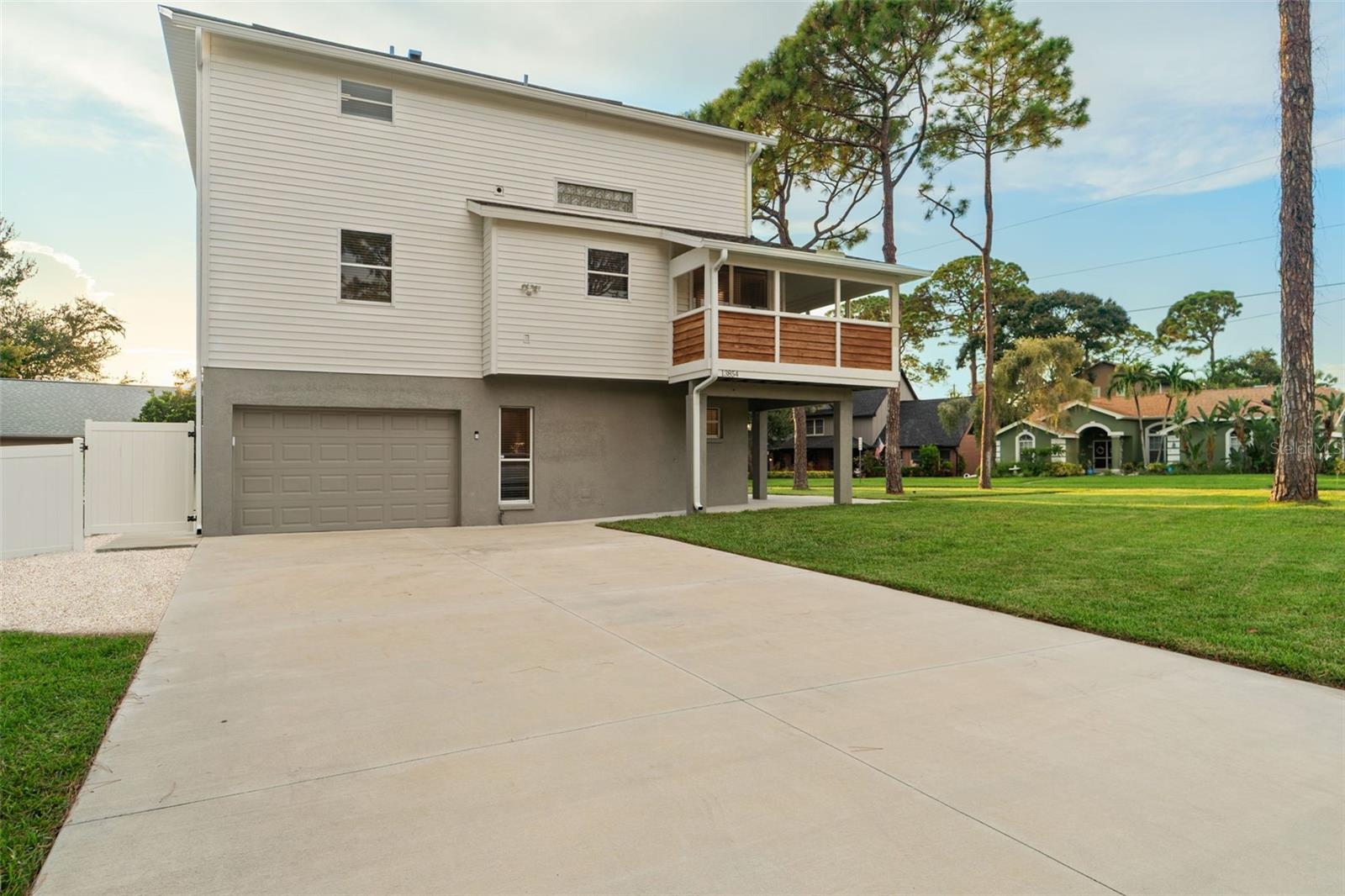 Massive driveway to accompany several vehicles and long enough for an RV or Boat. Has additional shell parking area off of the driveway for a boat/trailer/toys or whatever is needed.