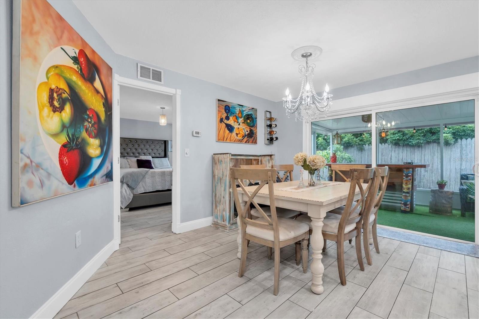 Dining room open to the kitchen and the screened in porch.  This house lives big!