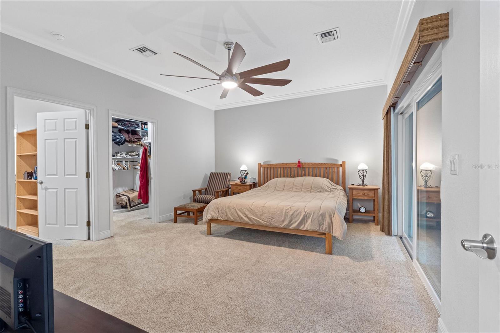 Primary bedroom with sliding glass doors to a walk out balcony