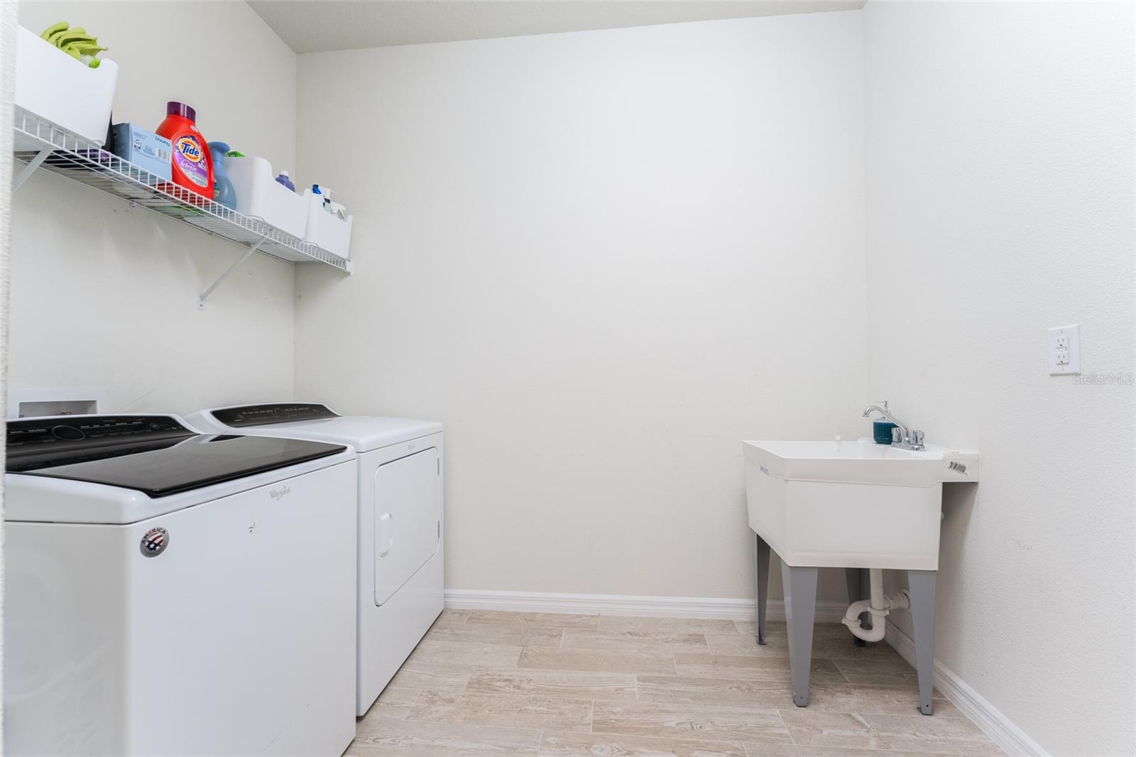 Downstairs Utility Room with Utility Sink and room for extra shelves or cabinets