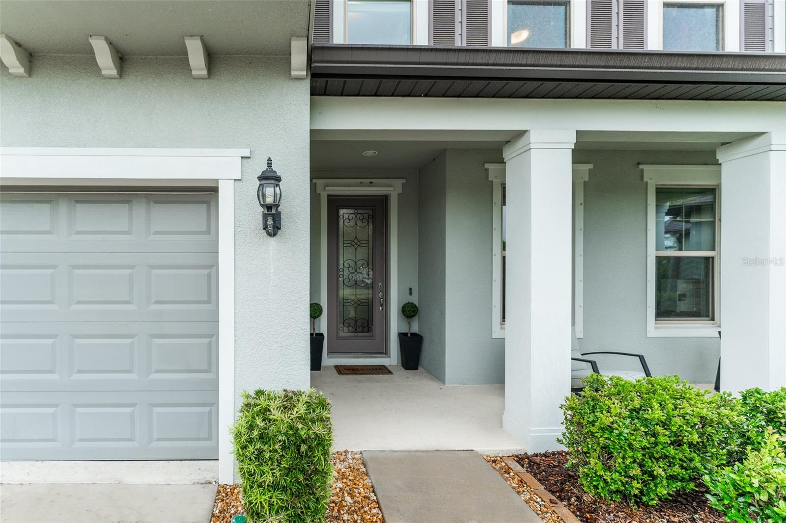 Welcoming Front Porch Entry with Detailed Glass Door