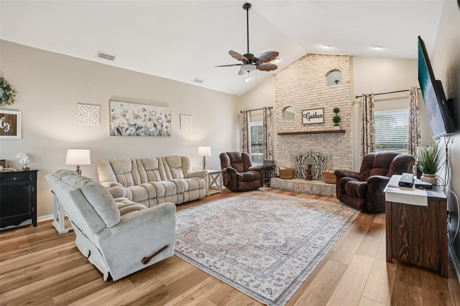 Family Room with wood burning fireplace and luxury vinyl plank floors