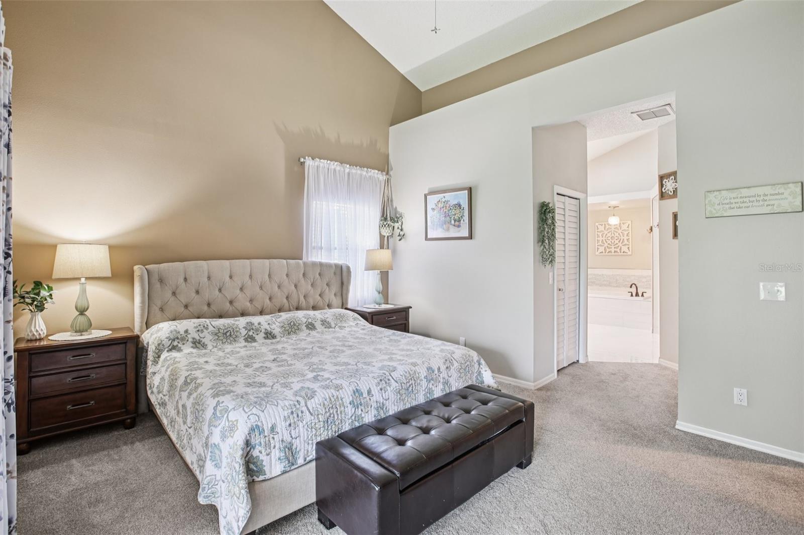 Primary bedroom with sliders to the lanai and beautiful back yard