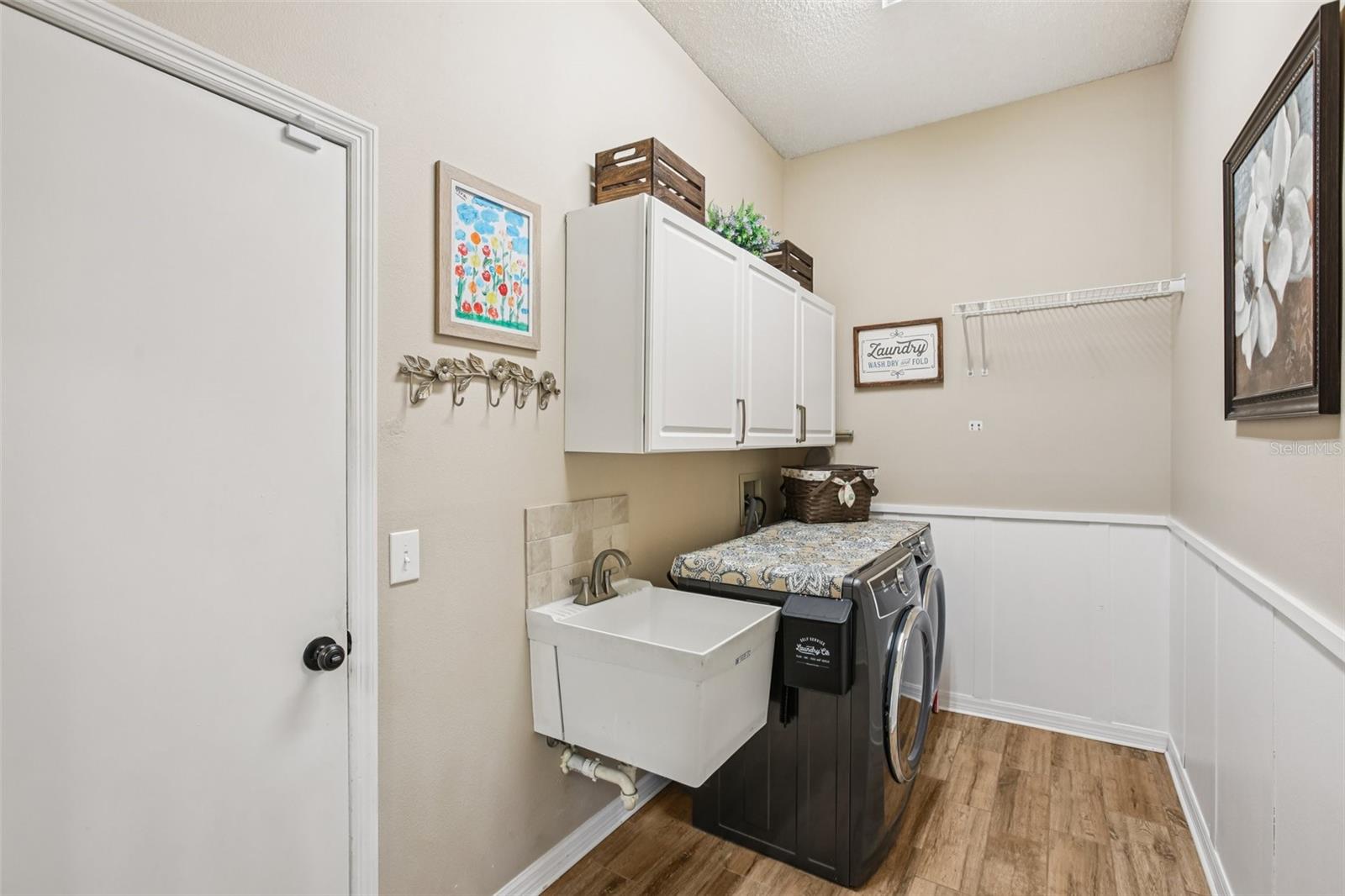 Laundry Room with new Electrolux washer and dryer and luxury vinyl planks