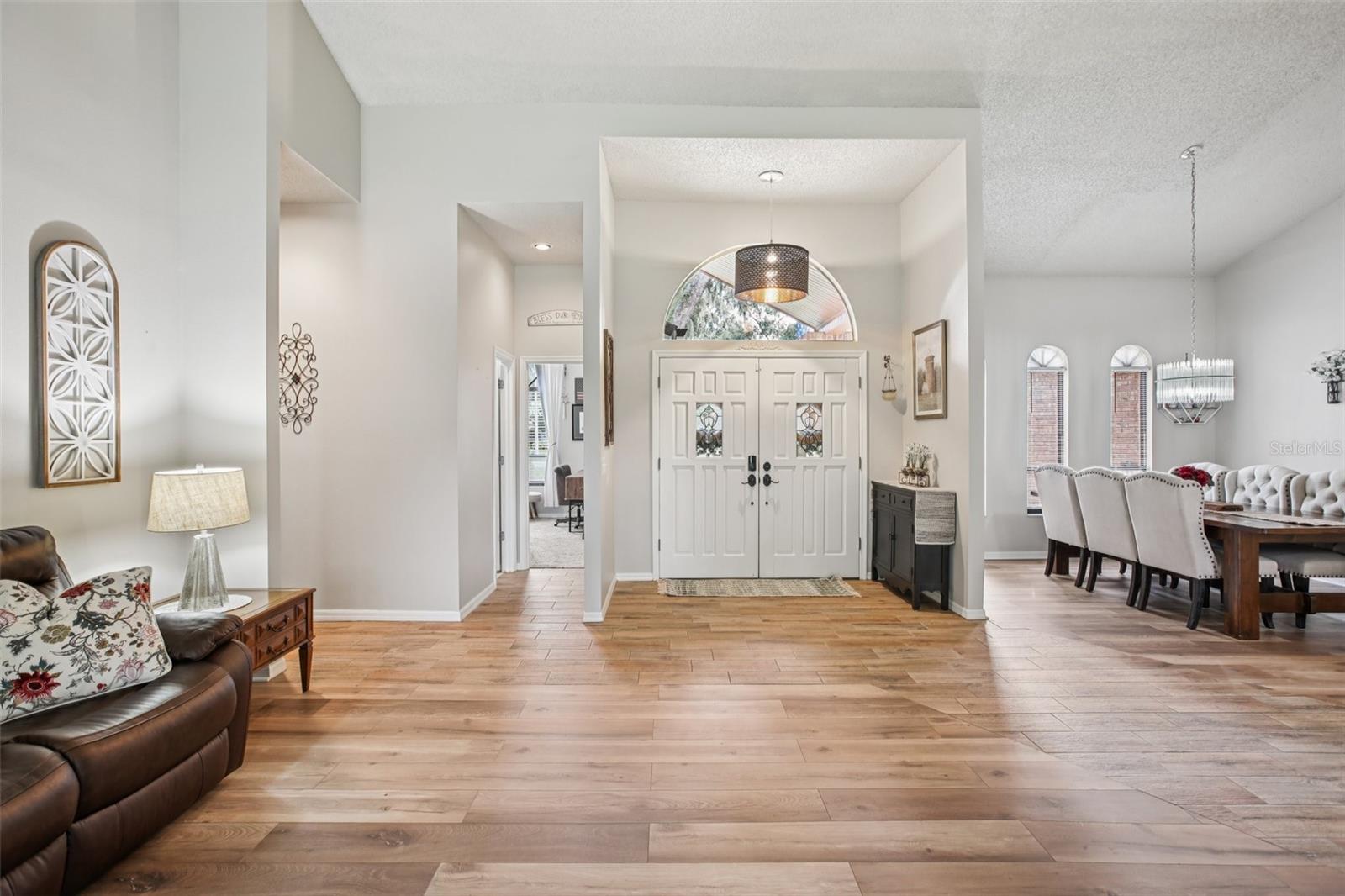 View of front door showing living room and dining room.  Floor are beautiful Luxury Vinyl Planks