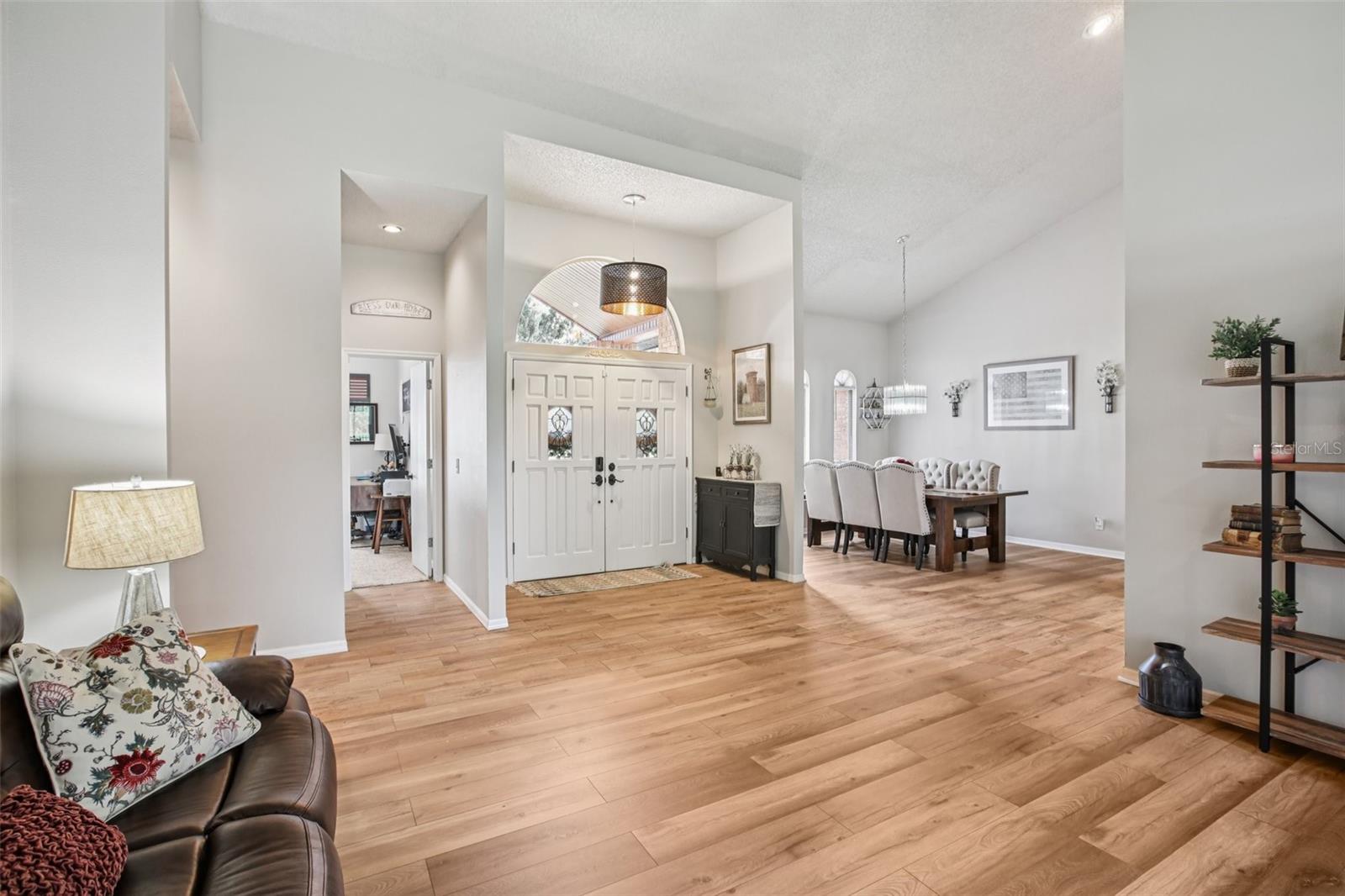 View of front door showing living room and dining room.  Floor are beautiful Luxury Vinyl Planks