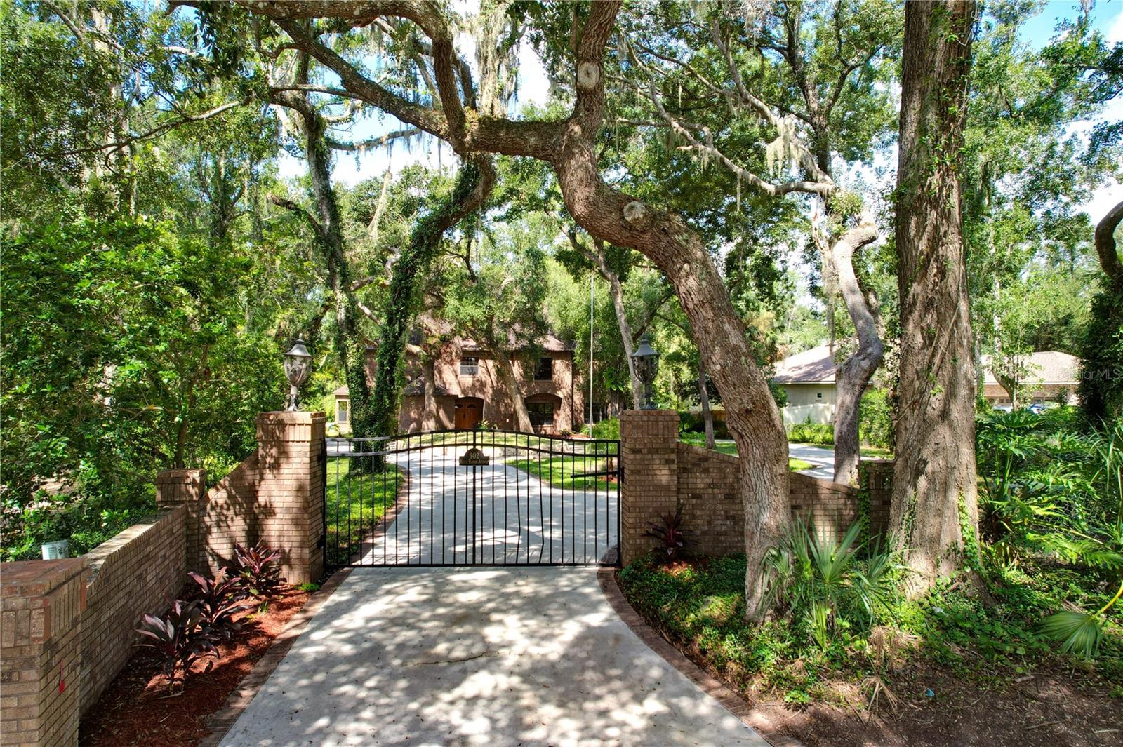 Private Gate & circular driveway with a 4 car garage situated on a cul-de-sac on over an acre with 138 feet of Alafia River frontage, a private dock, and riverside deck.