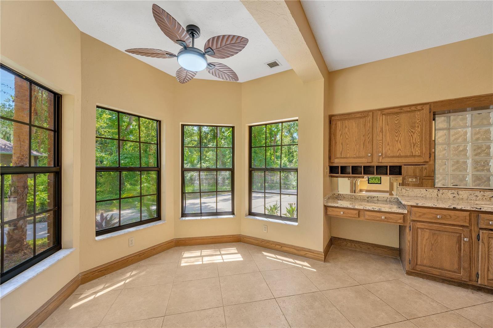 Eat-in area surrounded by 4 windows overlooking the side yard.