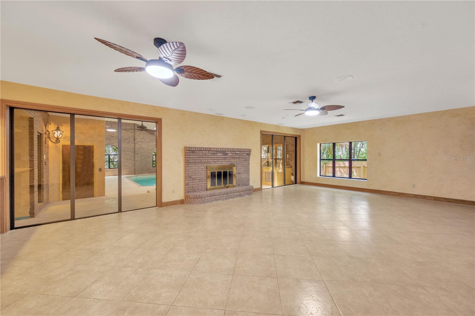 Two 3-panel sliding glass pocket doors vanish to reveal the stunning enclosed indoor pool & spa atrium.