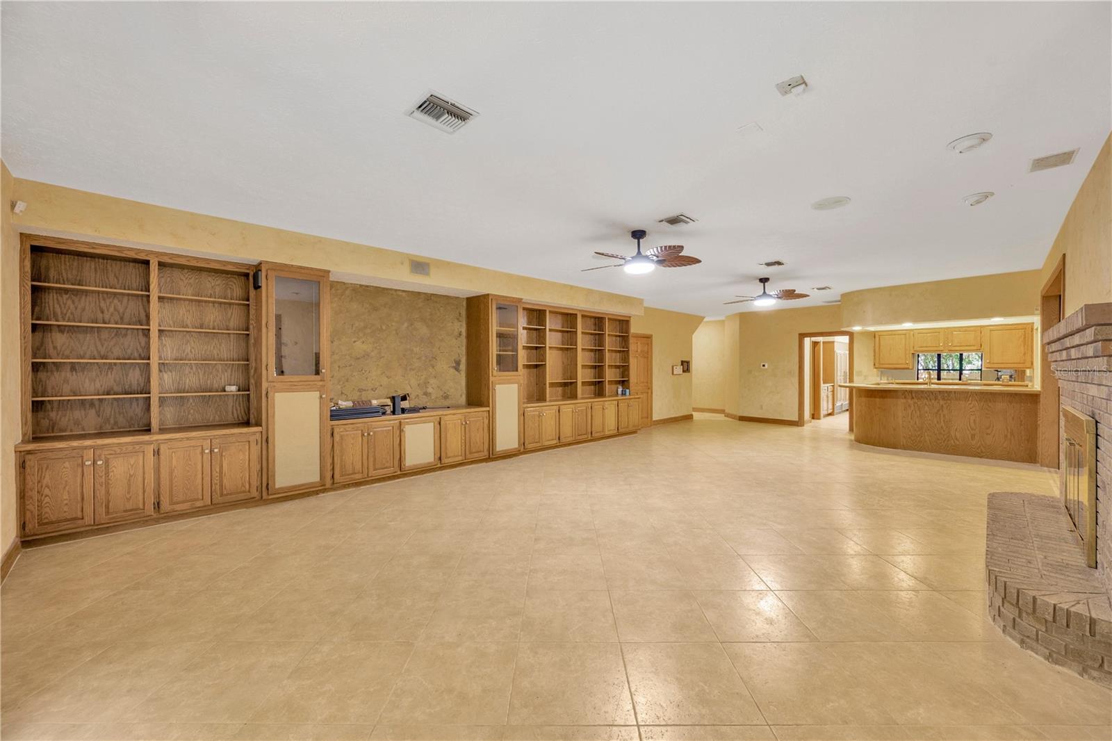 Custom-built oak shelves and cabinetry, a wet bar and surround sound system set the tone for relaxation.