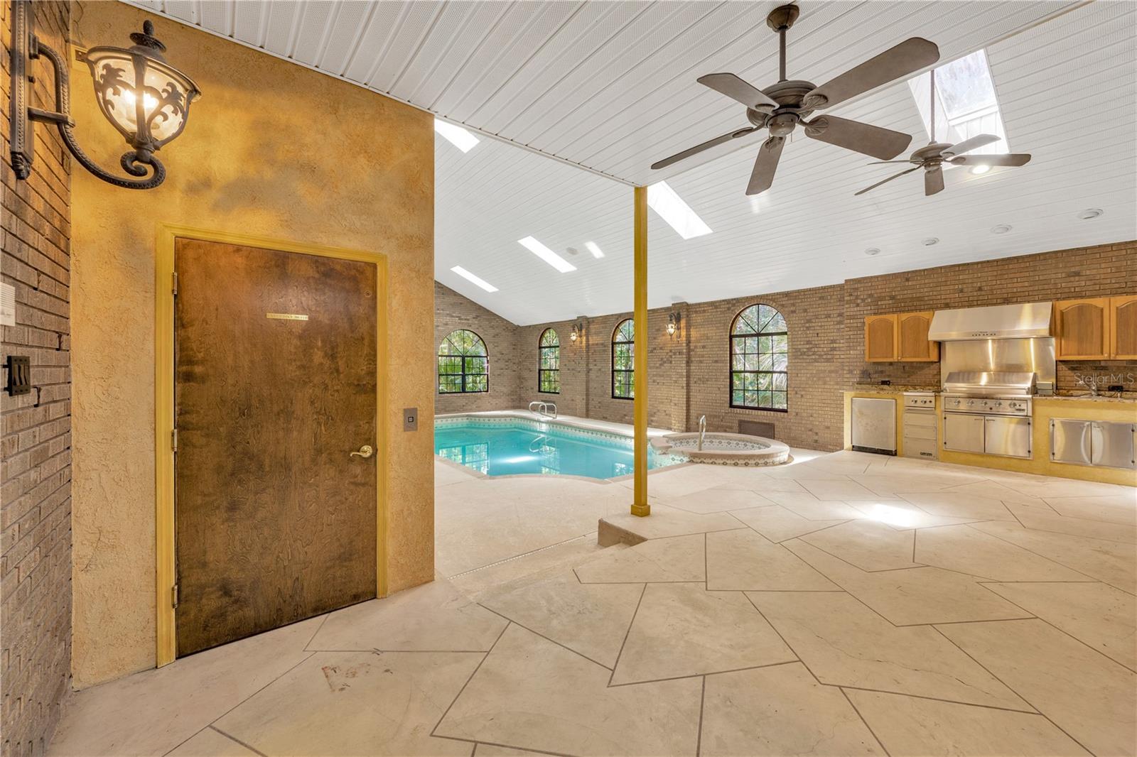 Just outside the Family Room glass sliding doors is a 2-story atrium for ultimate enjoyment & entertaining! The door conceals an elevator to the 2nd floor balcony outside of the Owner's Suite.