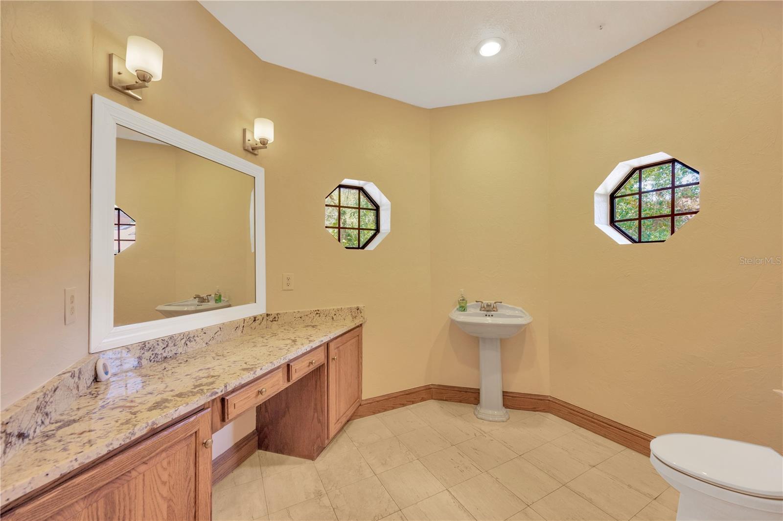 Half bathroom adjacent to foyer and formal dining room.