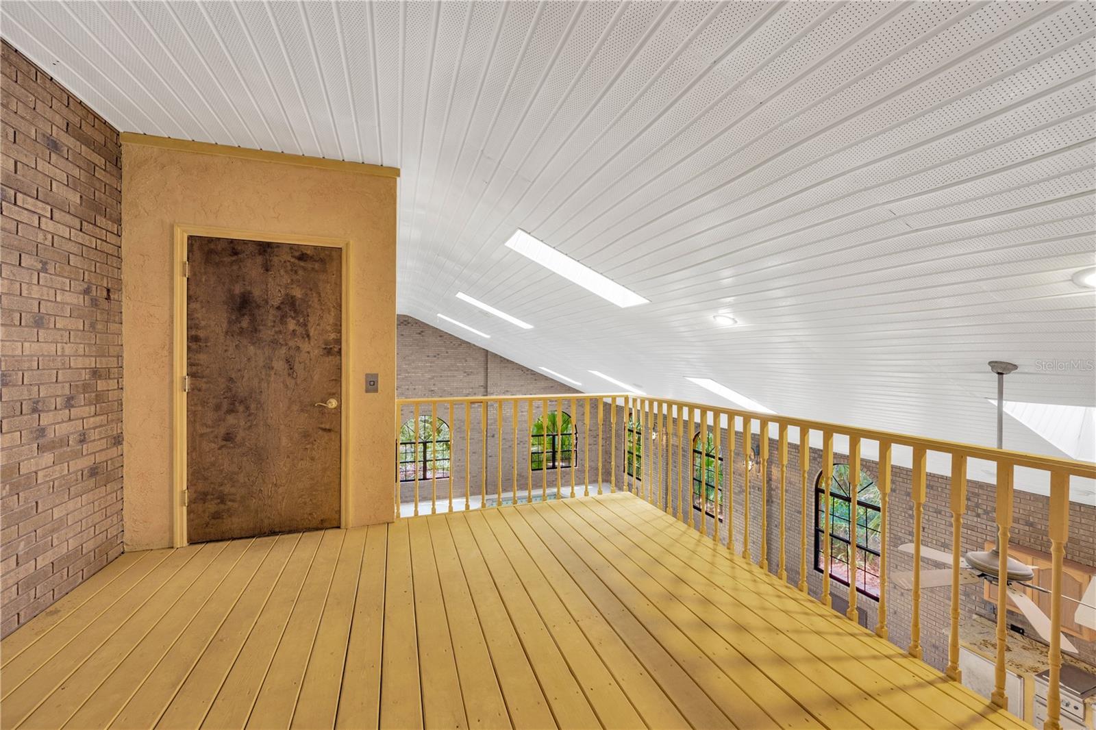 Just outside the double glass doors is a balcony with access to an elevator & overlooks the pool/spa atrium below.