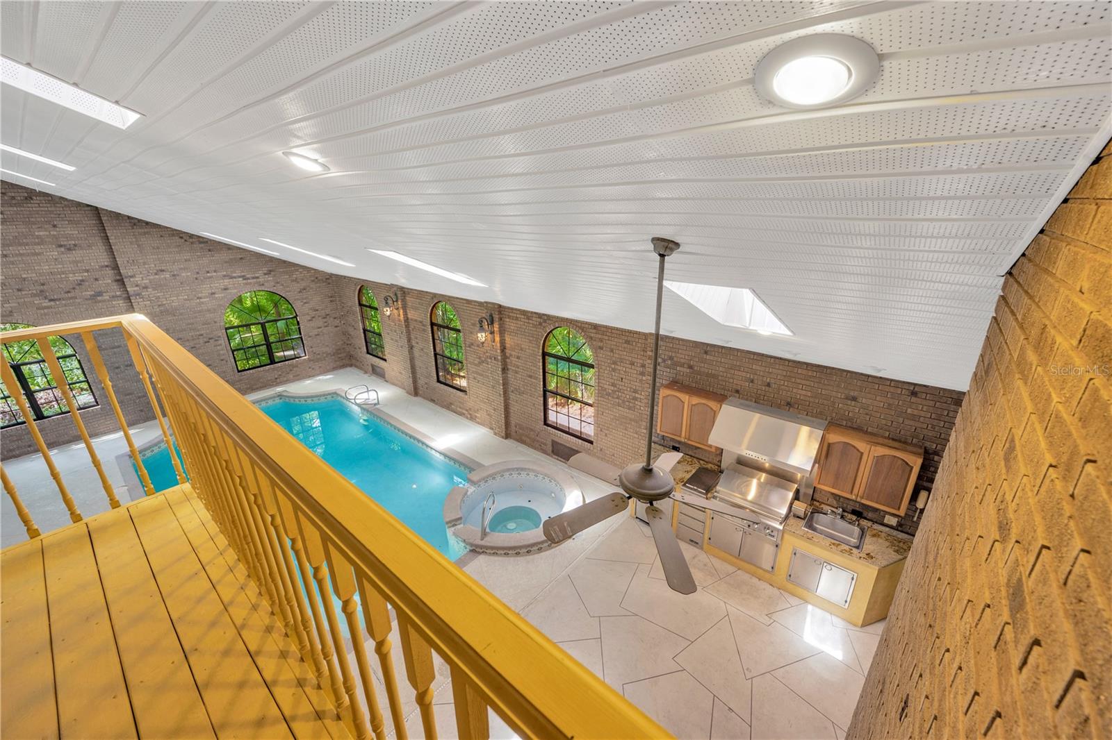 View of Pool & Spa & Summer kitchen below from balcony.