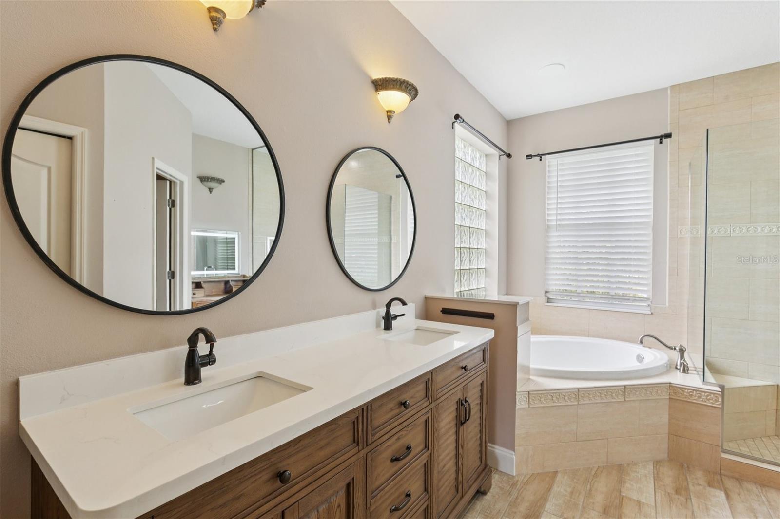 PRIMARY BATH HAS ALL THE PAMPERING YOU NEED WITH DOUBLE VANITY SINKS, SOAKING TUB AND WALK-IN SHOWER!