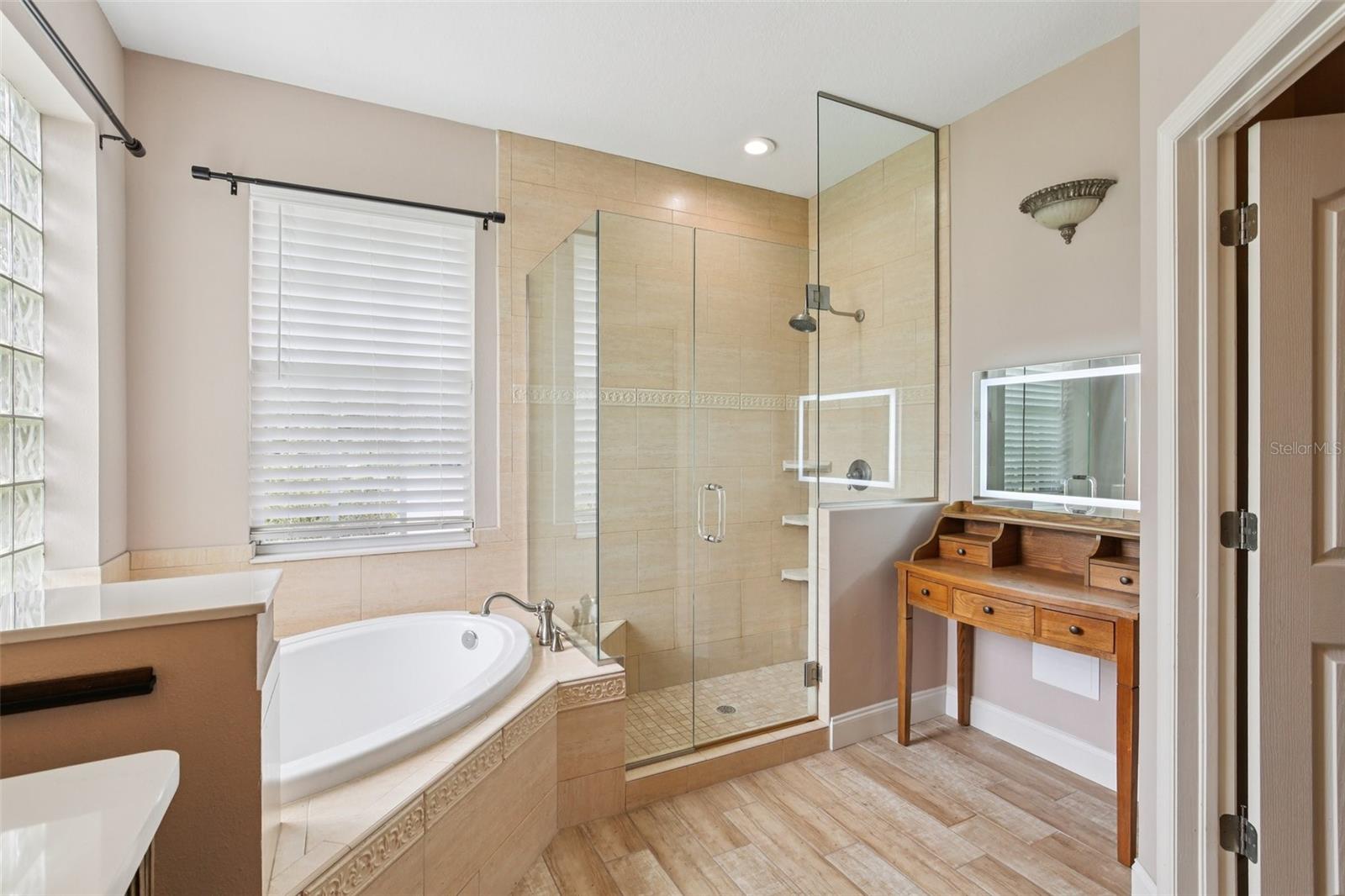 PRIMARY BATH HAS ALL THE PAMPERING YOU NEED WITH SOAKING TUB AND WALK-IN SHOWER!
