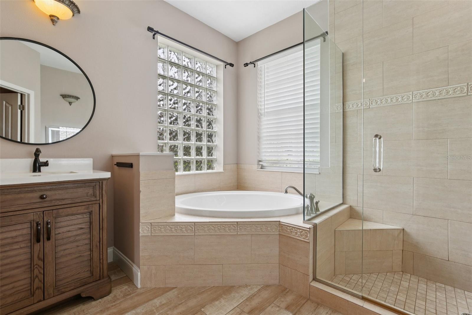 PRIMARY BATH HAS ALL THE PAMPERING YOU NEED WITH SOAKING TUB AND WALK-IN SHOWER!