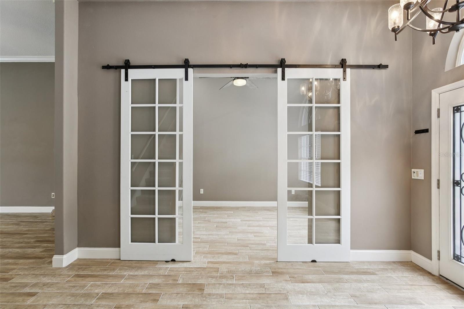 BEAUTIFUL AND BRIGHT ENTRY WITH SPACE SAVING BARN DOORS TO OFFICE