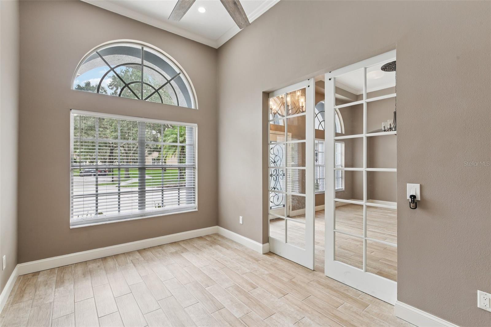 GLASS BARN DOORS ENHACE LIGHTING IN THE OFFICE