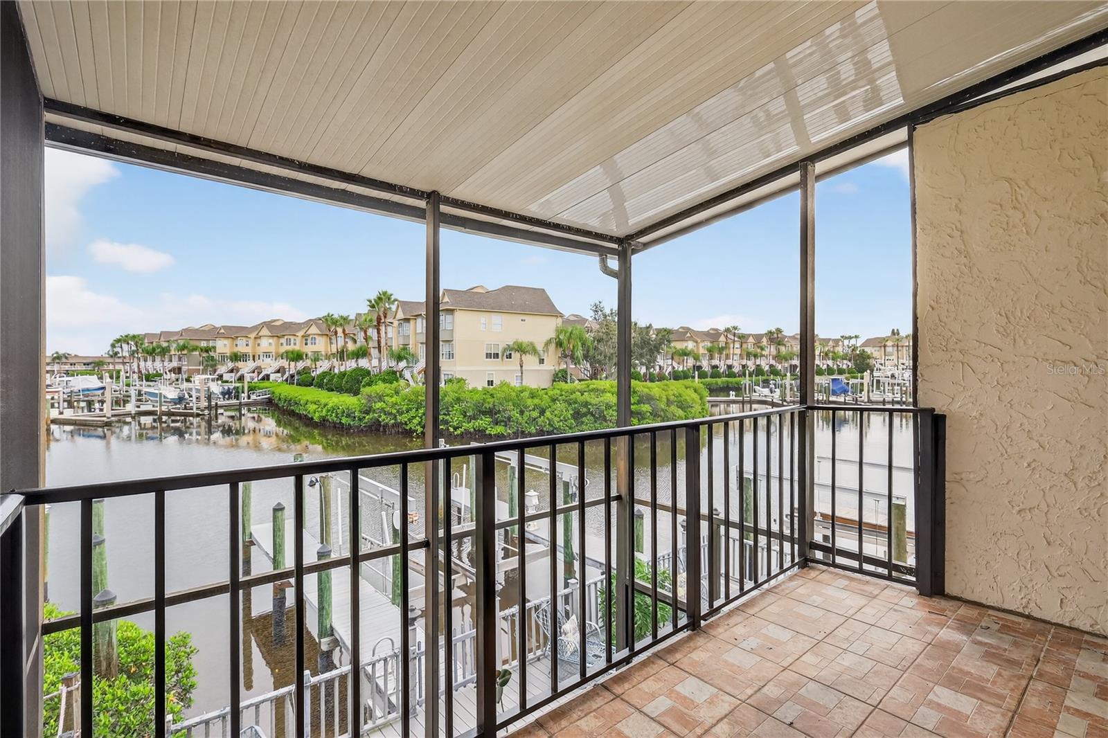 Master bedroom balcony overlooks water and patio.