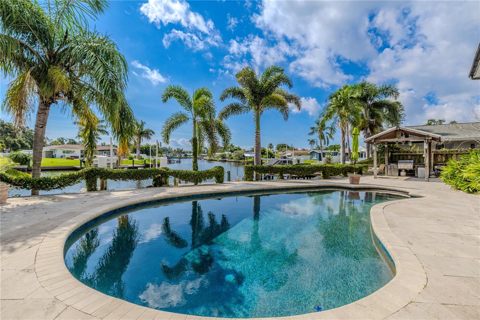 The oversized 18,000-gallon pool is a true backyard centerpiece, featuring a PebbleTec interior finish for beauty and durability. Recently updated in 2024 with a new pump and filter, the pool runs on a premium Jandy/Zodiac salt generator system for easy maintenance and sparkling water. Surrounding the pool, the upgraded travertine deck provides an elegant and slip-resistant surface, enhanced with integrated lighting for evening ambiance.